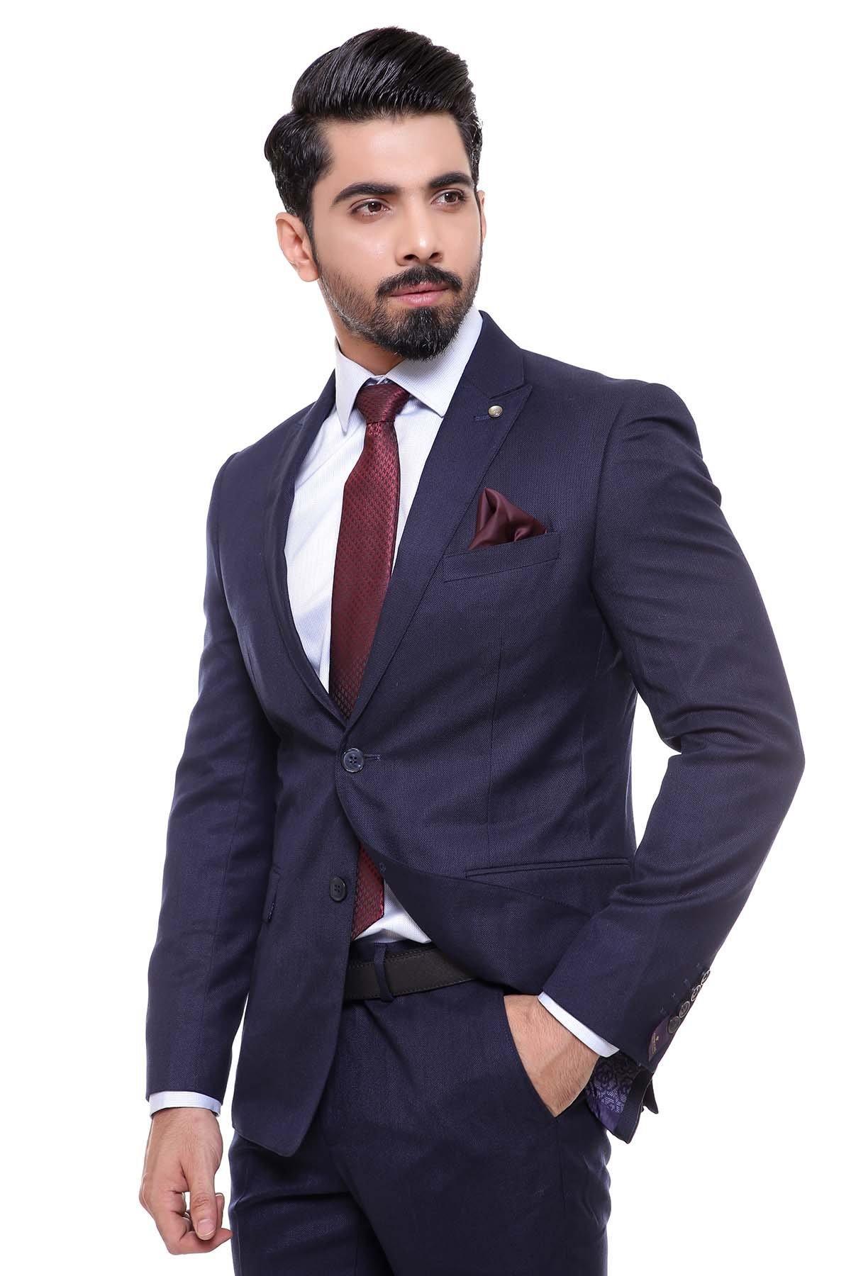 Dark navy two-piece suit with blazer and trousers, burgundy tie, folded pocket square.
