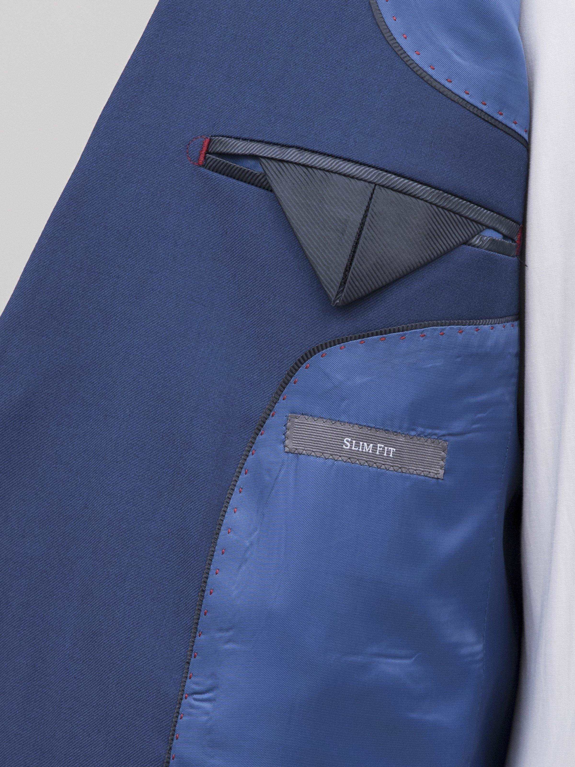 Blue suit inner pocket with “SLIM FIT” label on lining