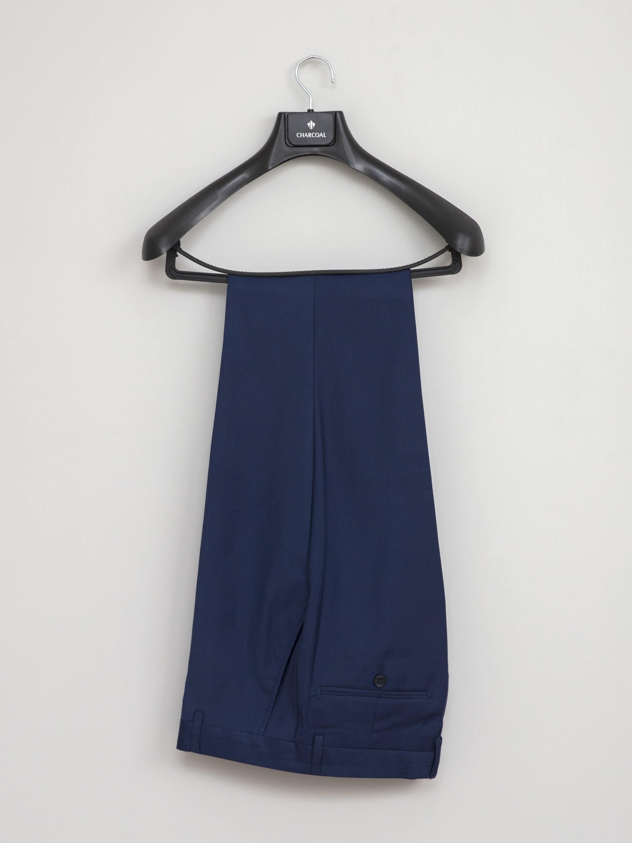 Blue slim-fit suit trousers hanging on black hanger