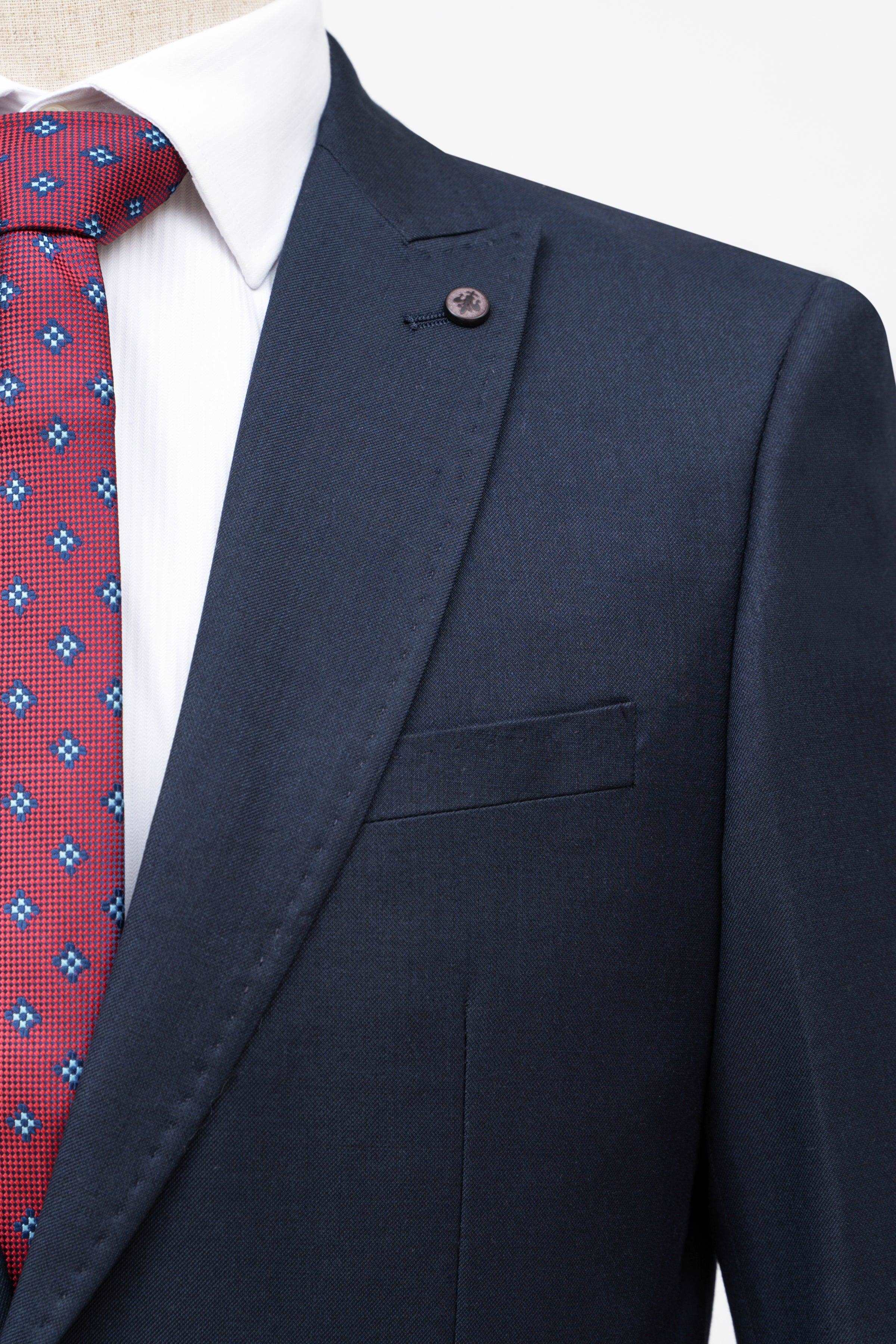 Dark navy suit jacket close-up with breast pocket and stitched lapel