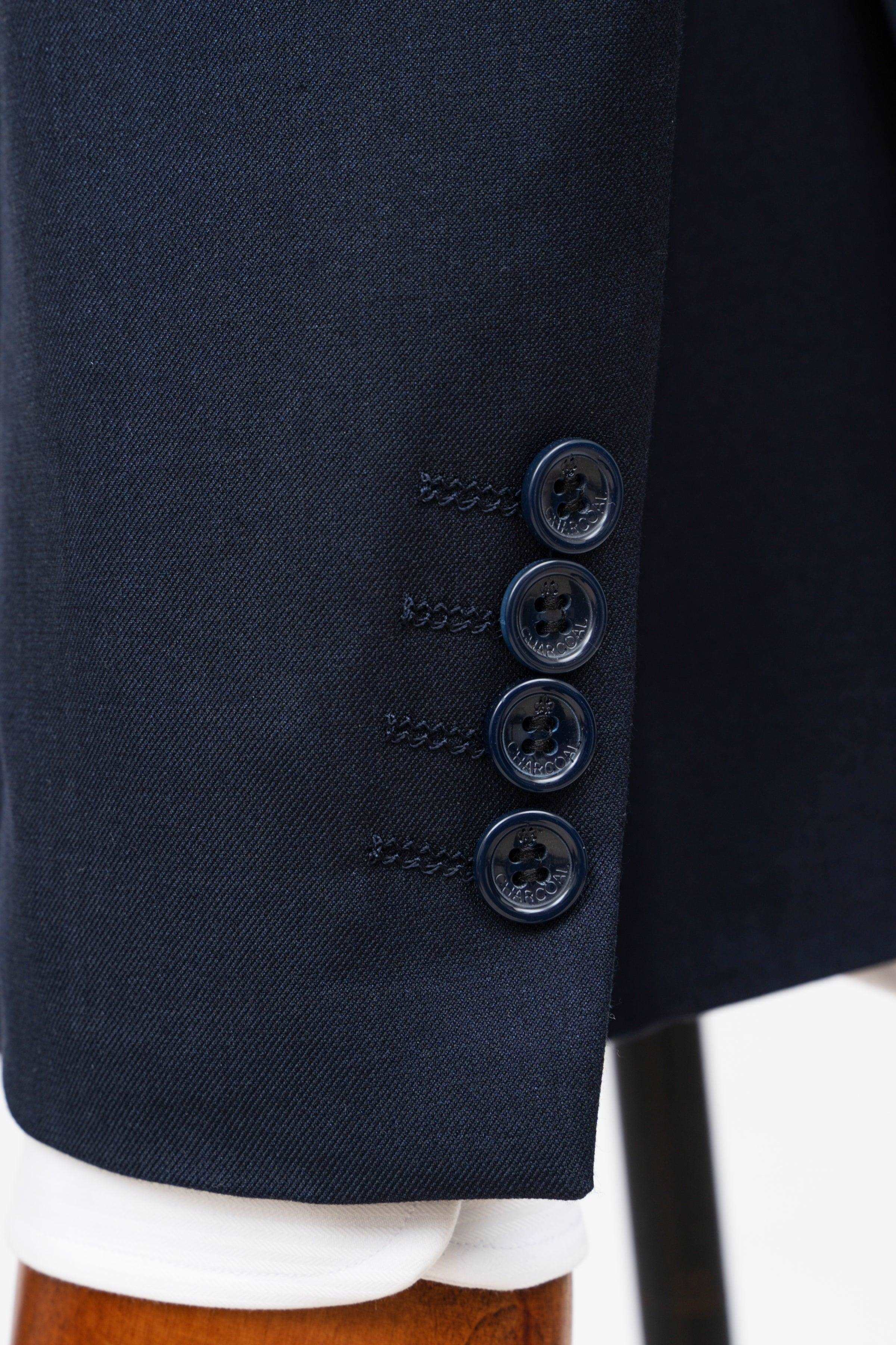 Dark navy suit jacket sleeve cuff with four-button cuff detail