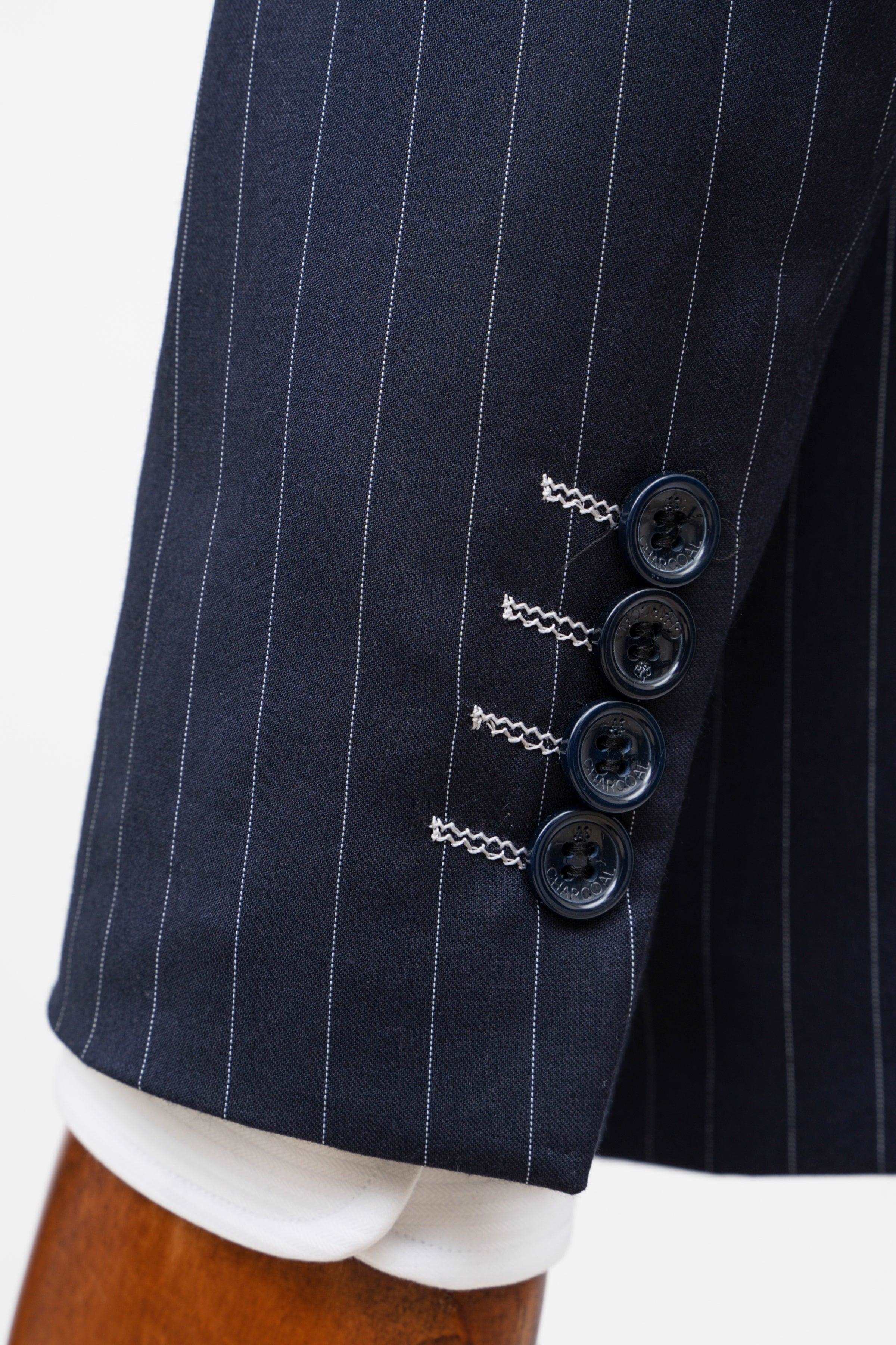 Navy pinstripe double-breasted suit jacket front with three dark buttons