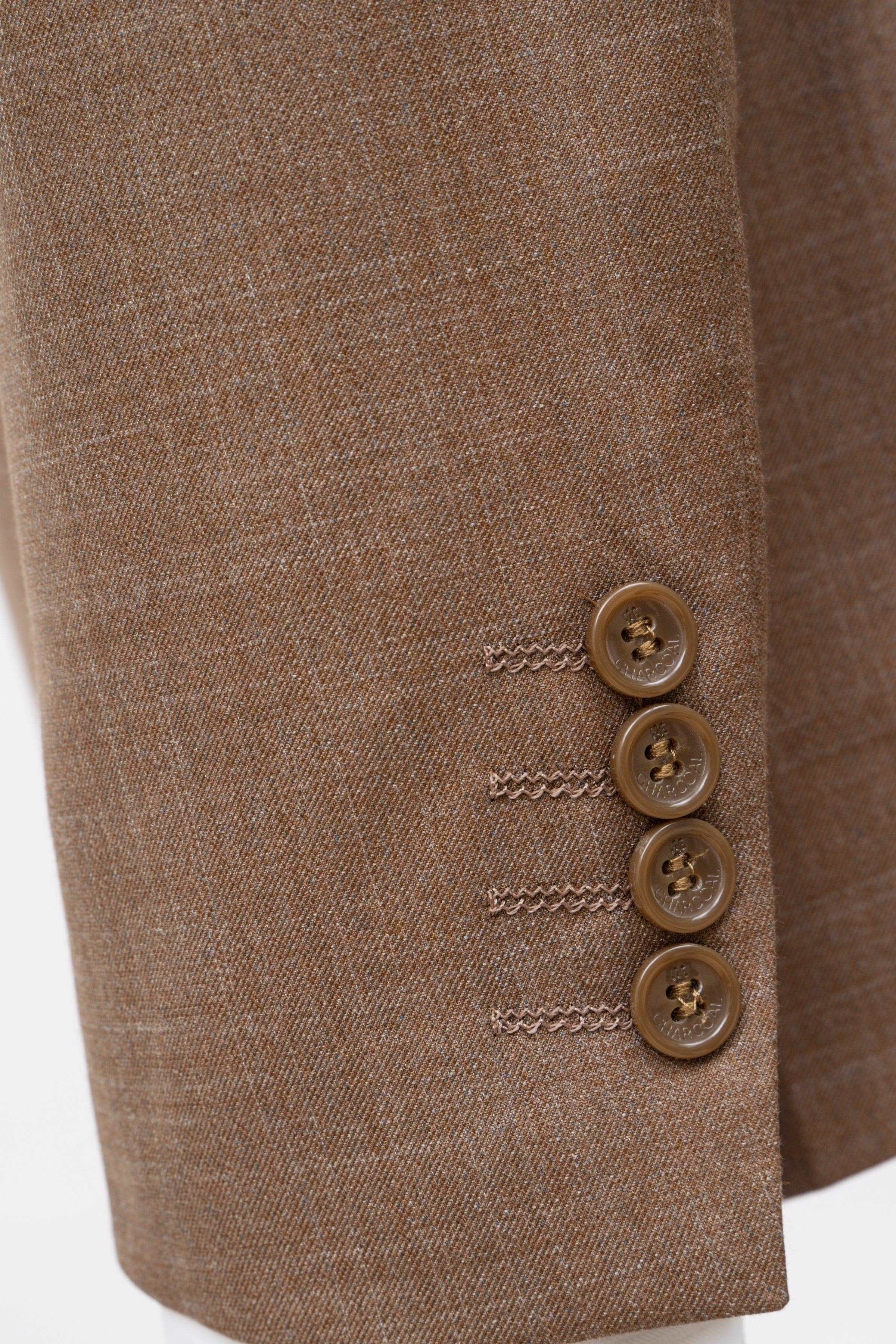 Light brown suit jacket sleeve detail with four brown buttons and stitched trim