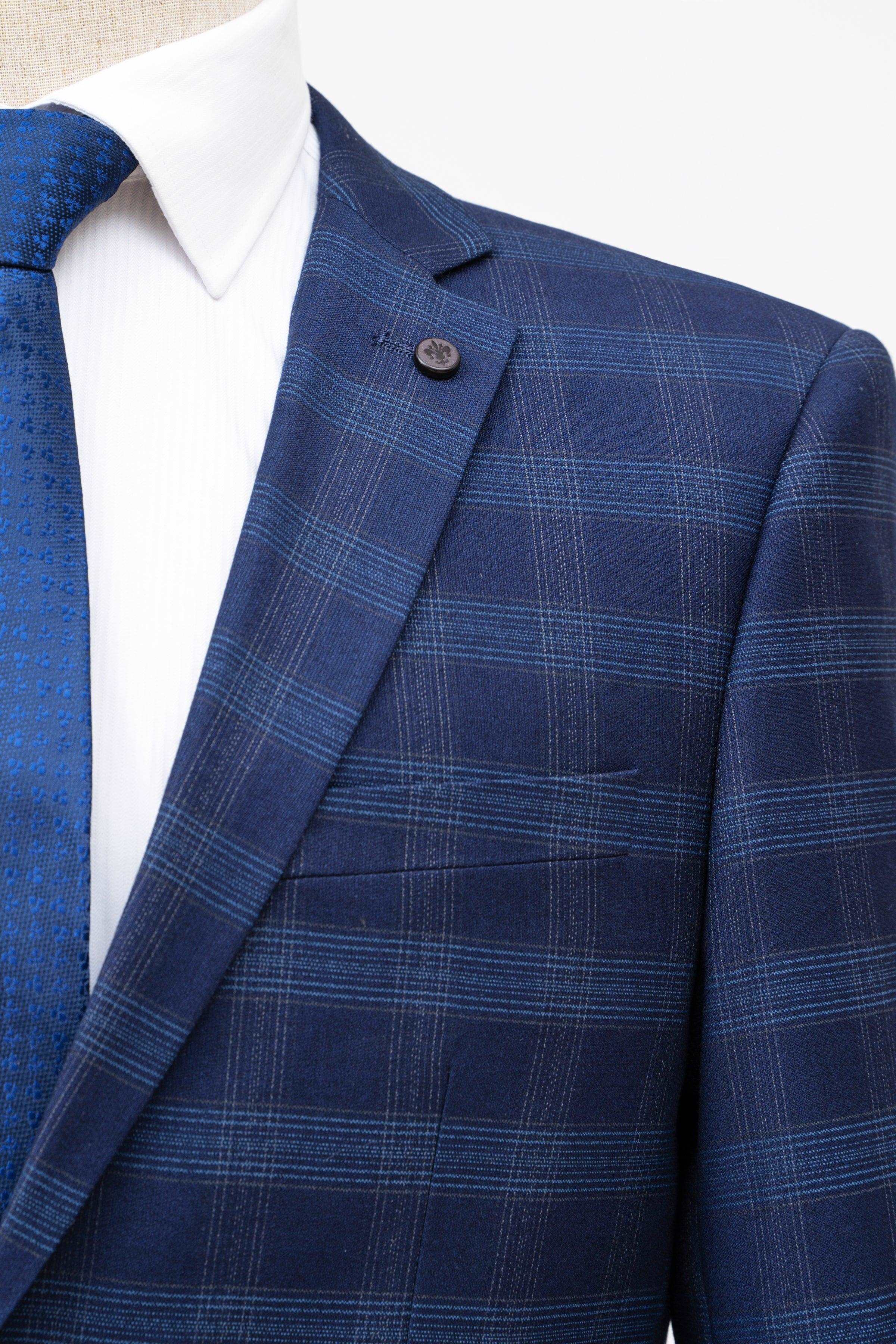 Navy check suit jacket lapel with welt chest pocket and two-button closure