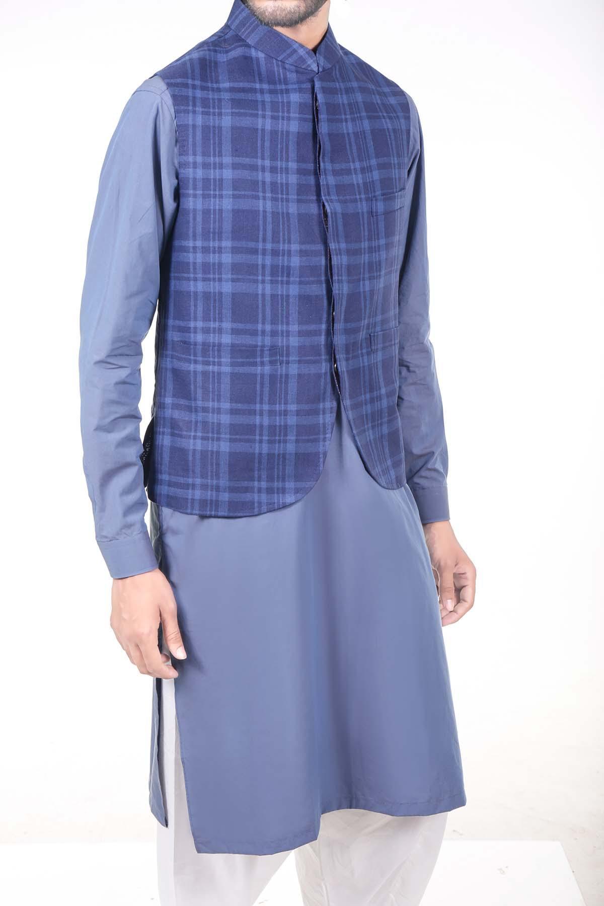 Navy check waistcoat worn over a blue shirt, open front hem