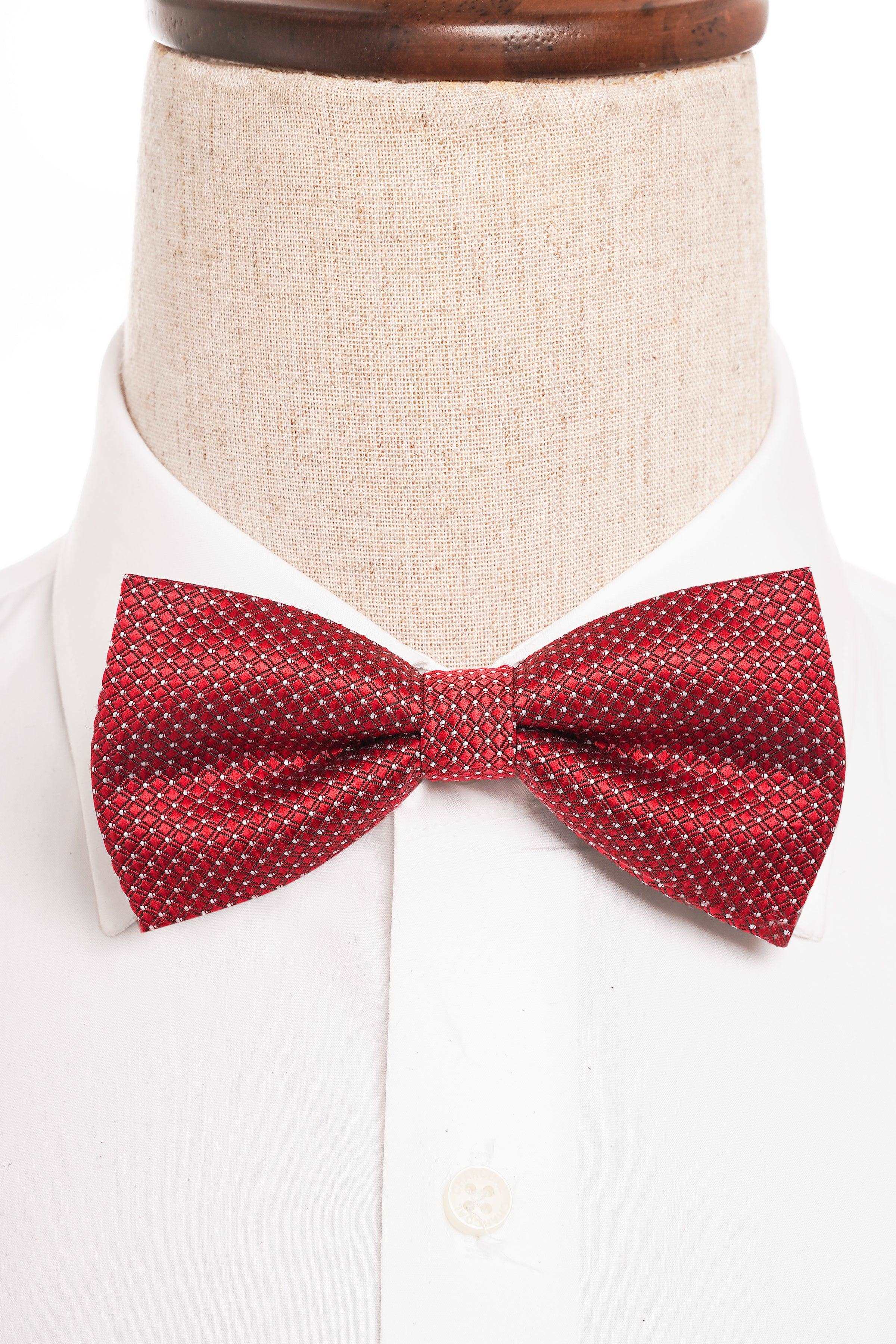 Red patterned bow tie on white shirt collar
