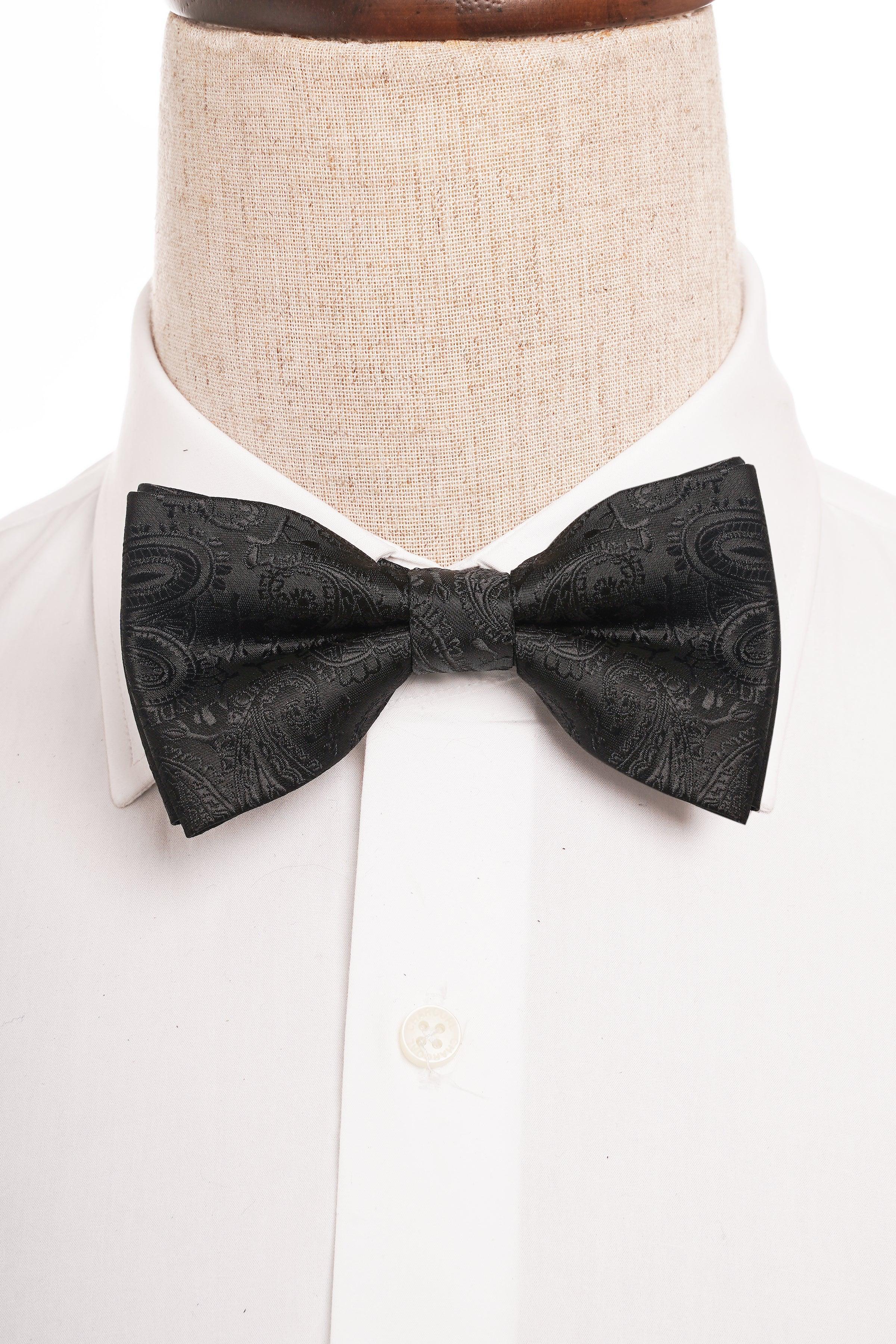 Black patterned bow tie on white shirt collar