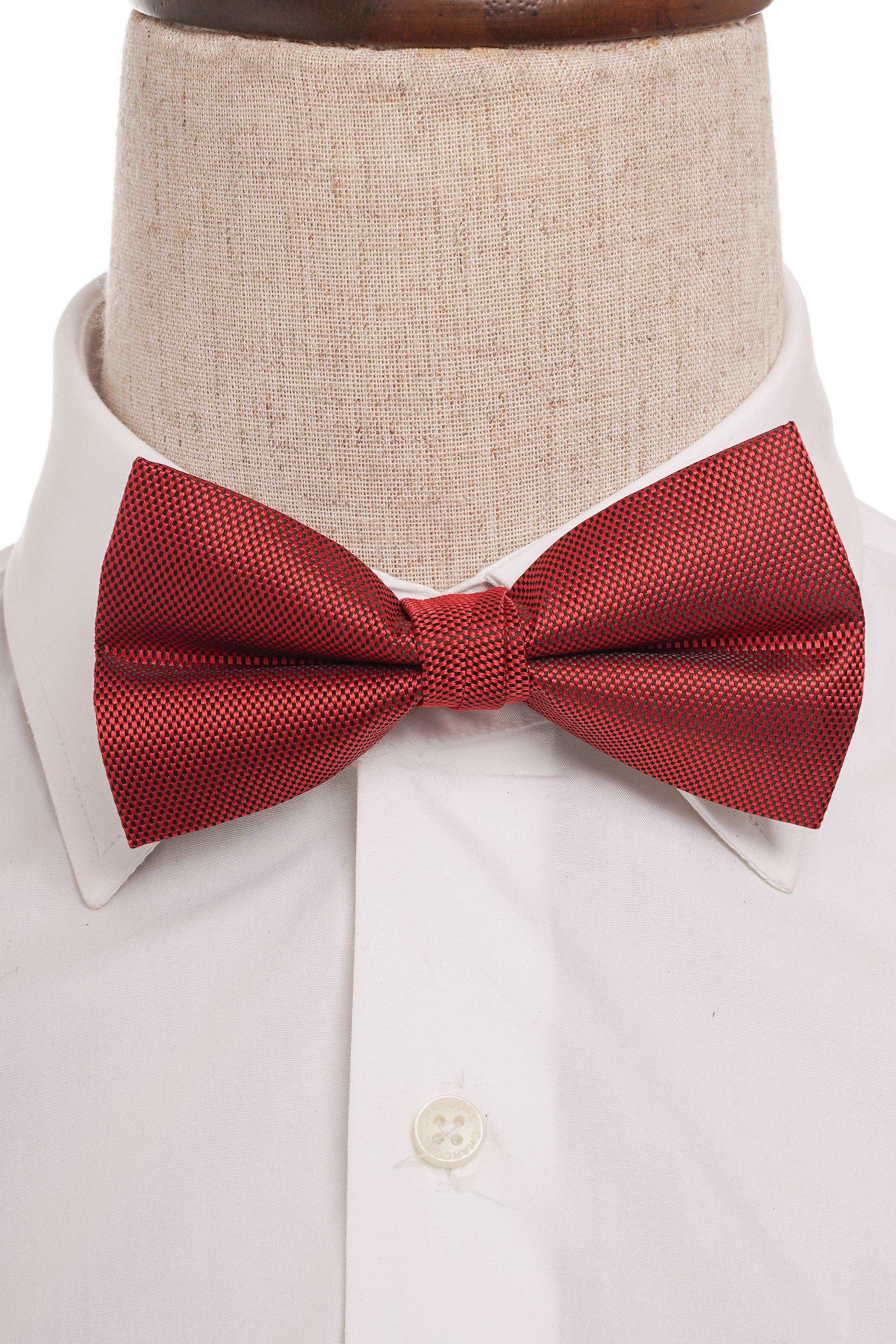 Red textured pre-tied bow tie on white dress shirt collar