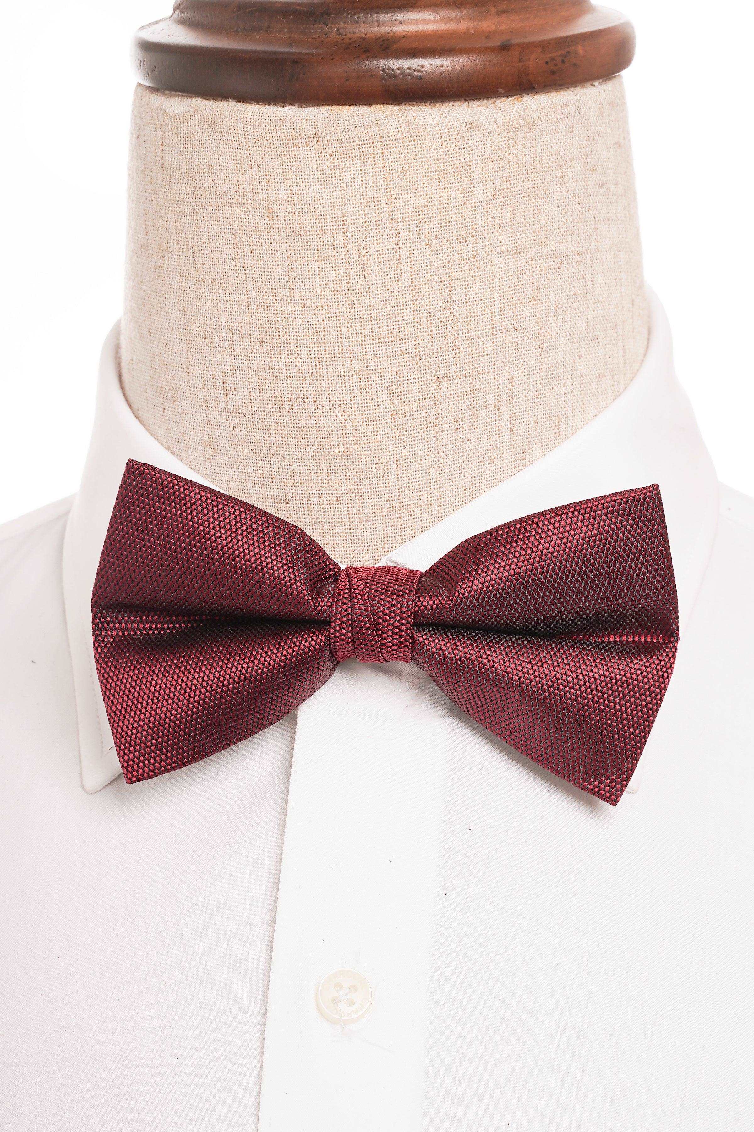 Burgundy textured bow tie on white dress shirt collar