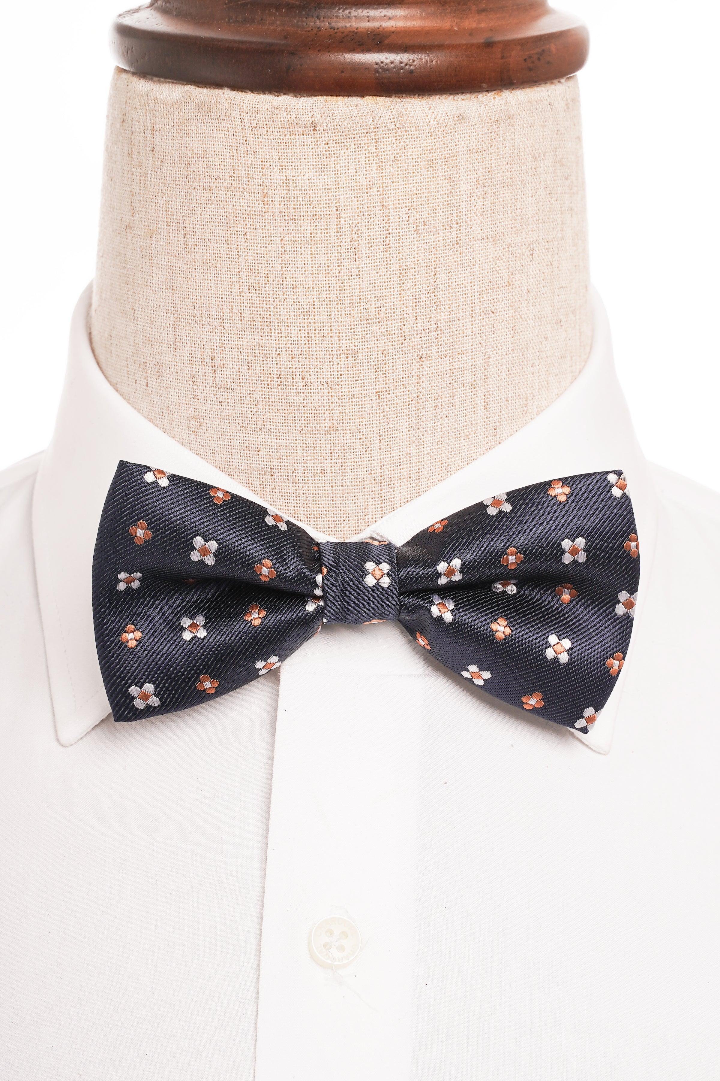 Pre-tied bow tie on collar, dark navy with pink floral pattern