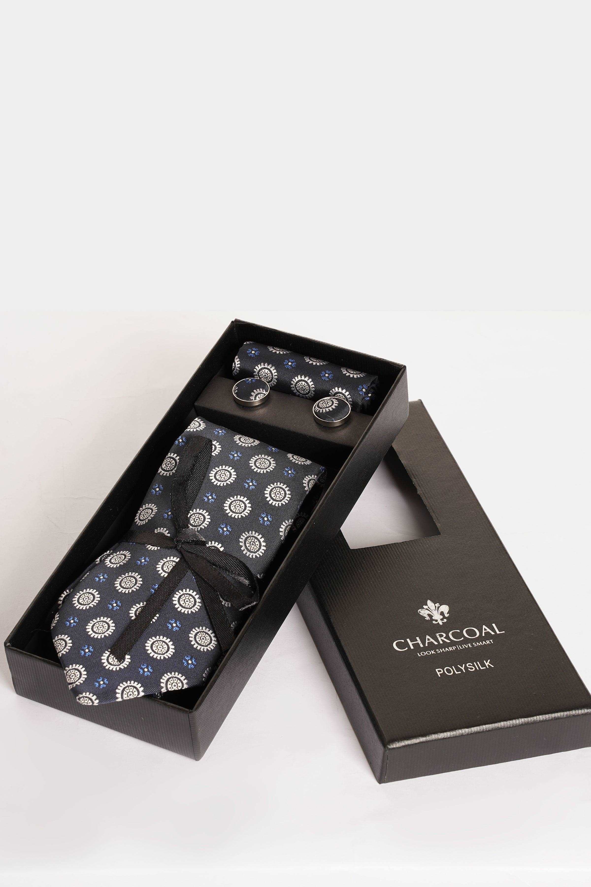 Tie set in box with patterned tie, pocket square, and silver-tone cufflinks