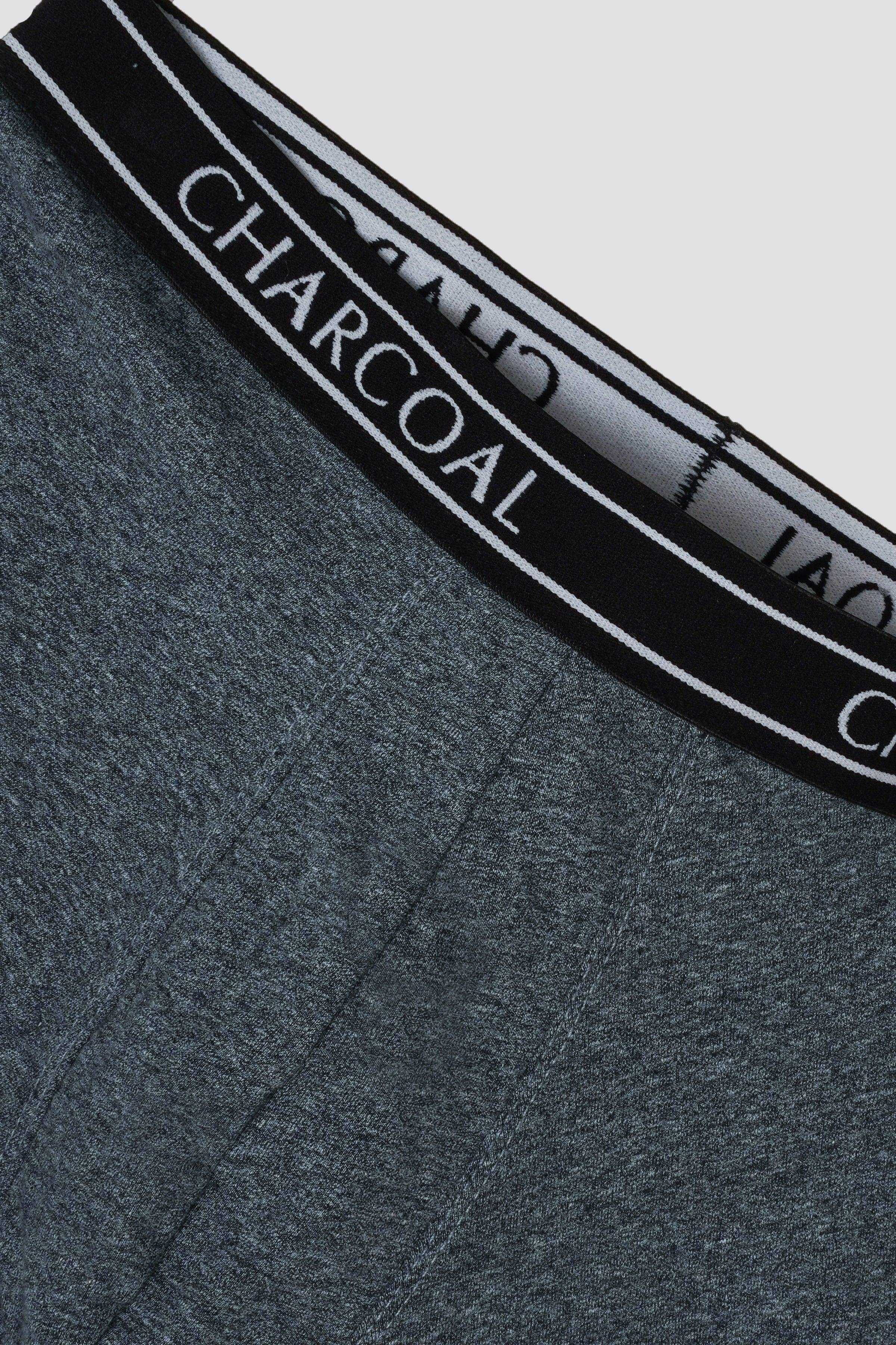 Close-up of knitted dark blue boxer waistband with black band and CHARCOAL text
