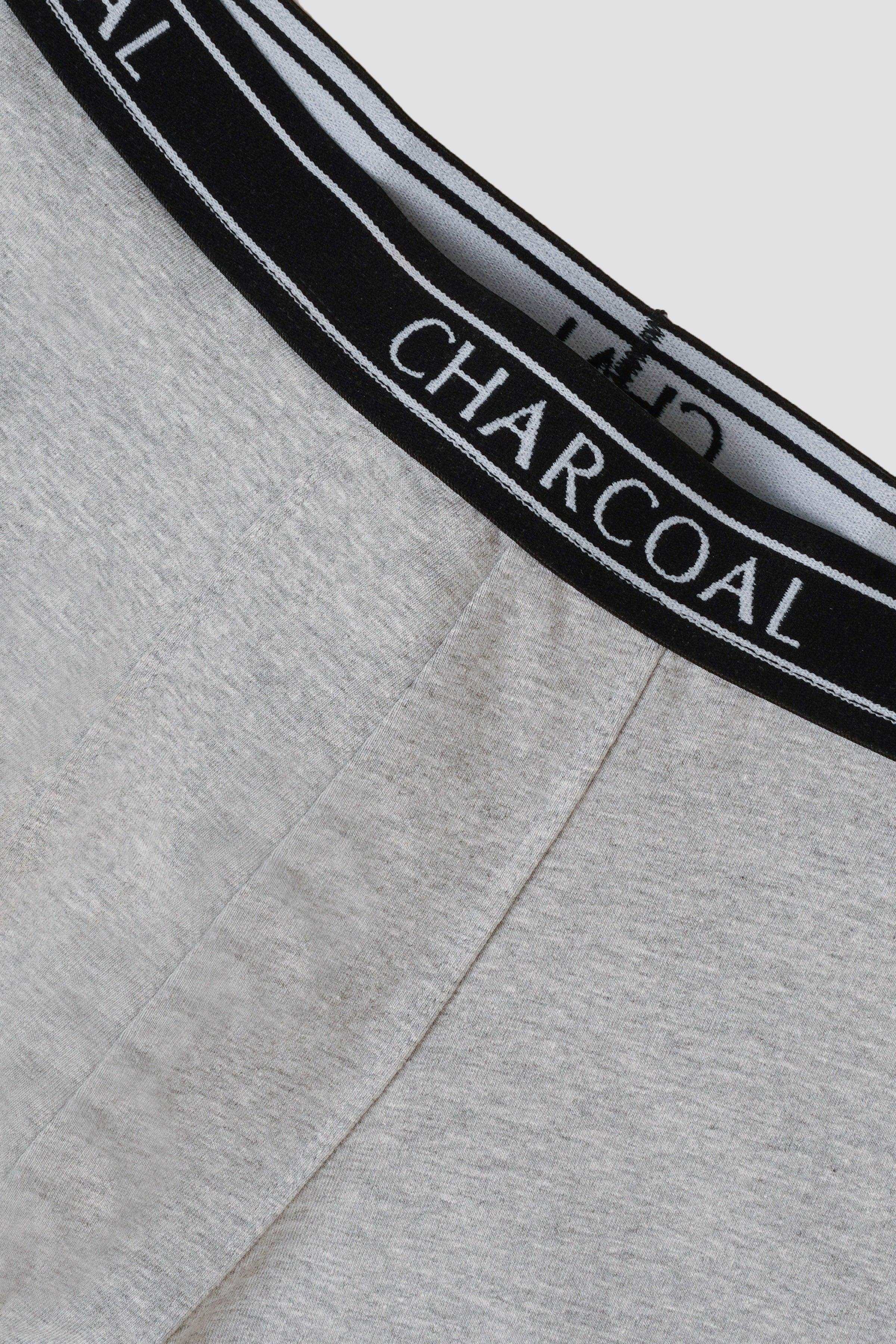 Grey knitted boxer shorts close-up: black waistband with charcoal logo print