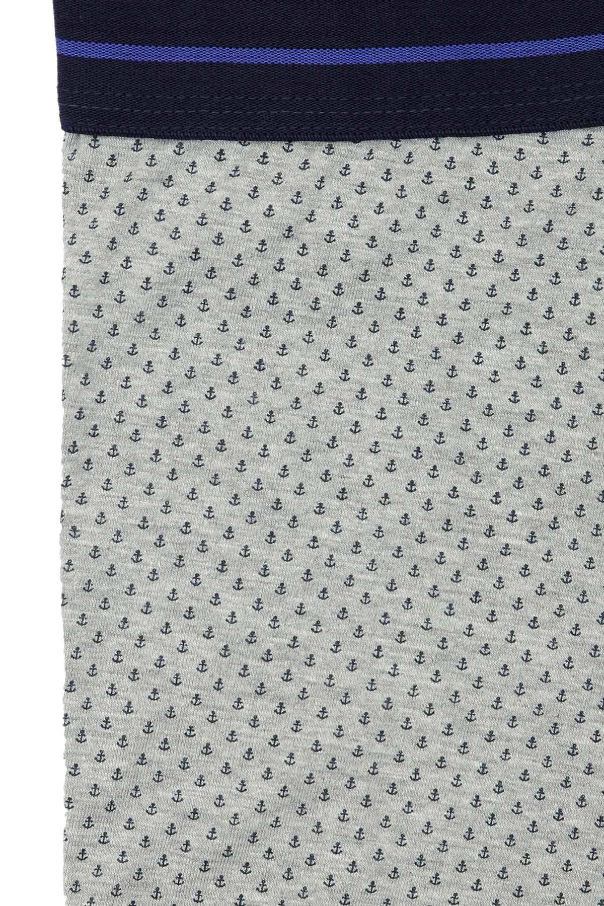 Close-up of grey boxer fabric with tiny anchor pattern and navy waistband