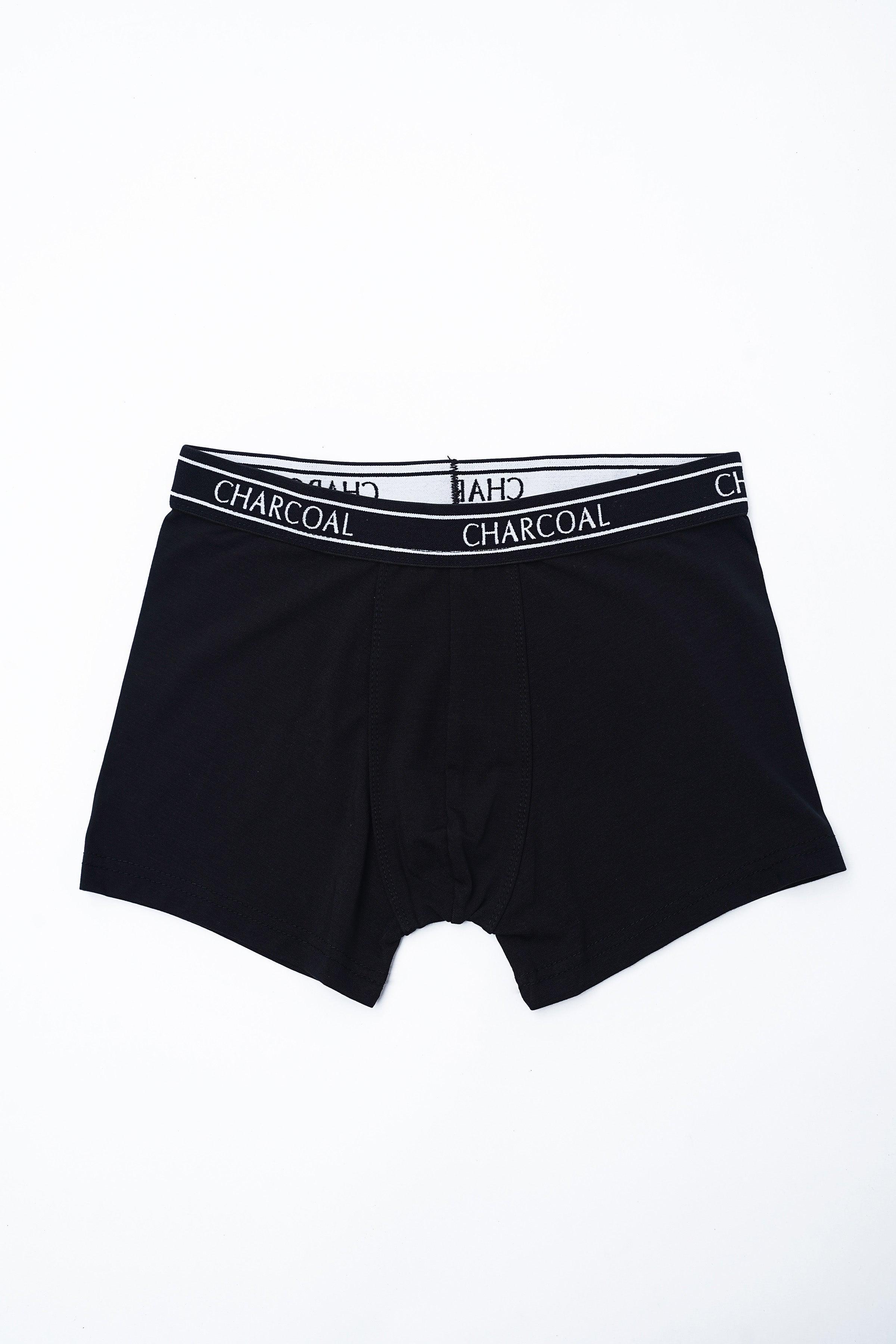 Plain black boxer shorts with elastic waistband and repeating CHARCOAL text