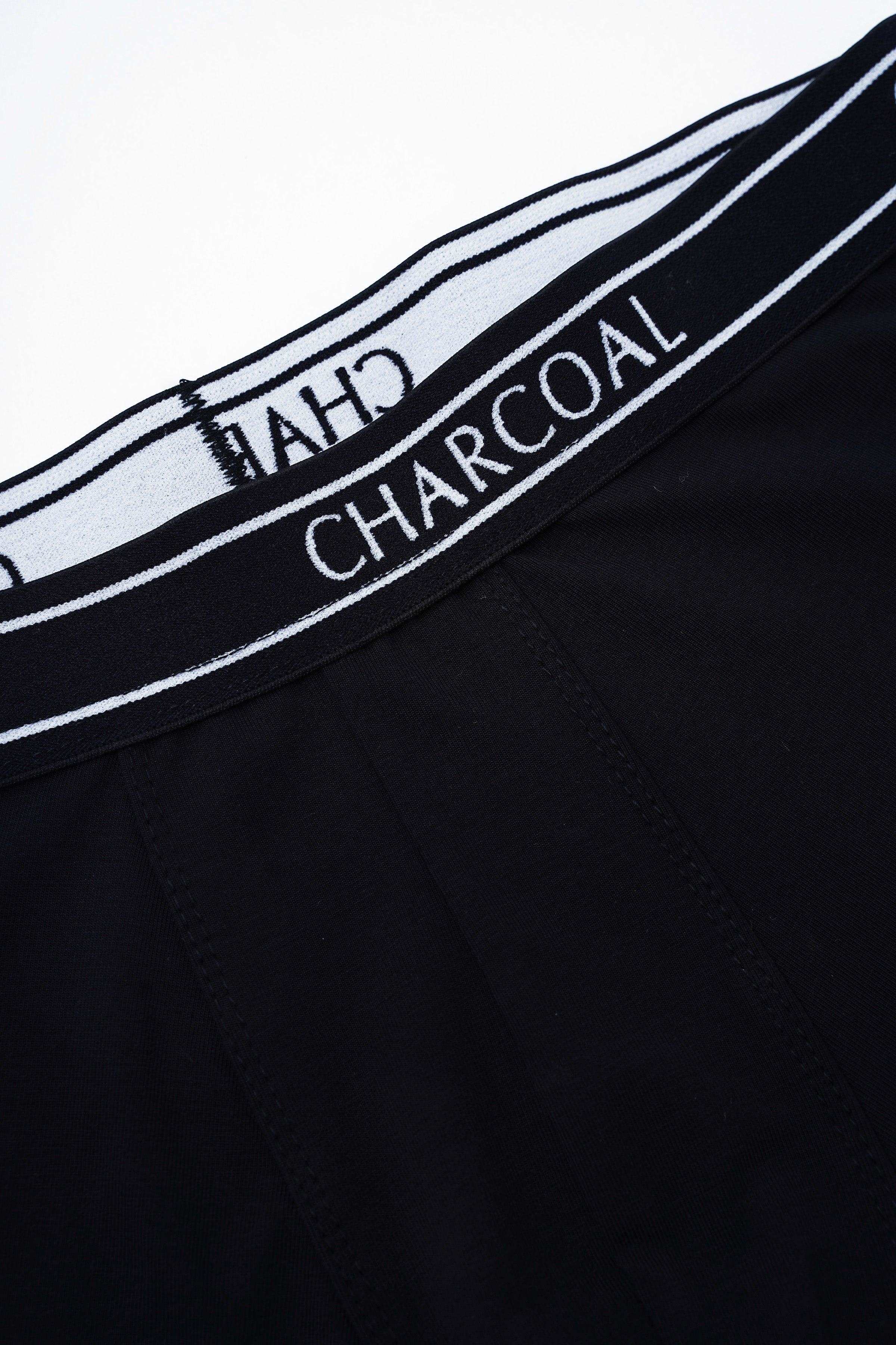 Black boxer shorts close-up of elastic waistband with CHARCOAL lettering