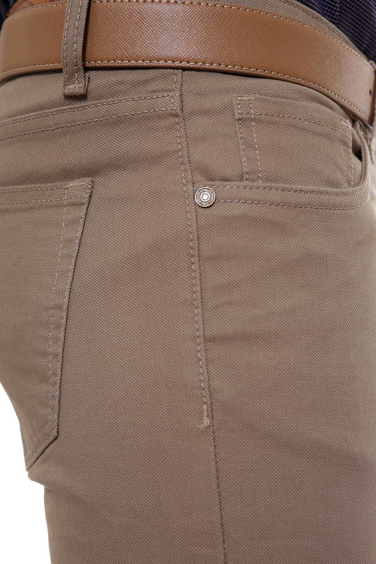 Khaki pants close-up: front pocket stitching and metal button