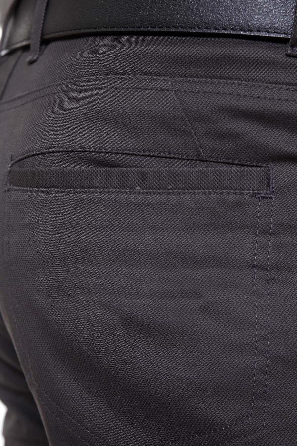 Dark grey pants pocket with stitched flap and fabric texture close-up