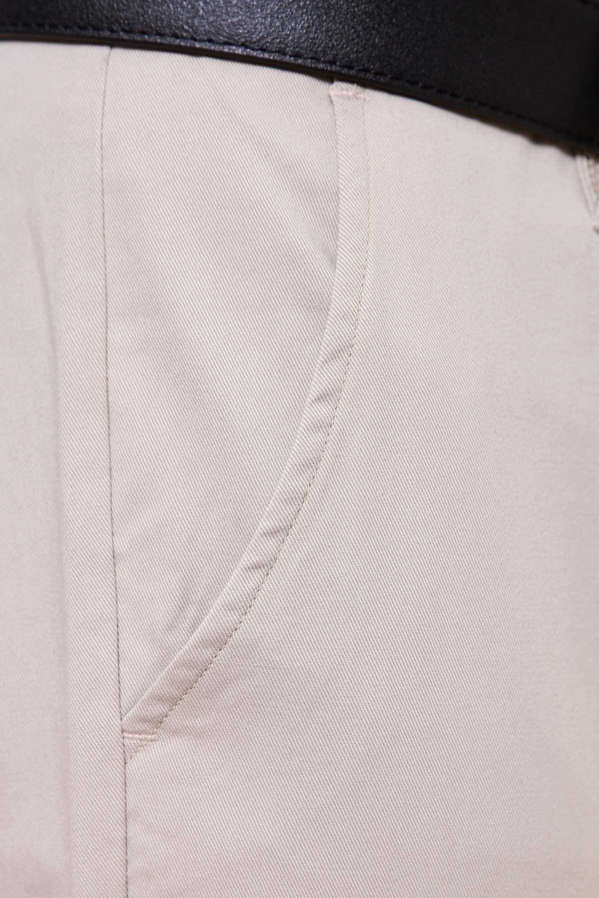 Beige pants fabric close-up with stitched seam detail