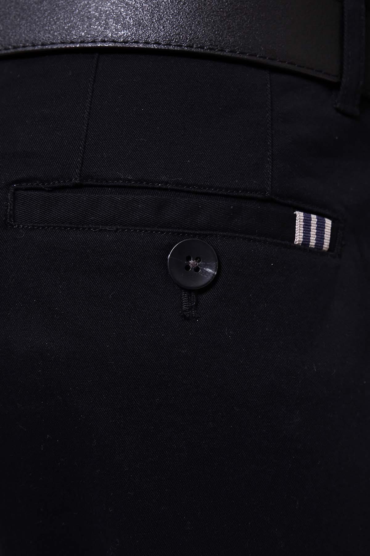 Black trouser pocket with button and stitched detail, small striped tab