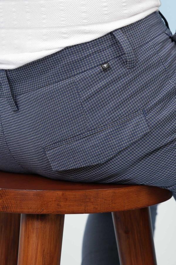 Ink blue trousers pocket detail with small logo badge and textured fabric