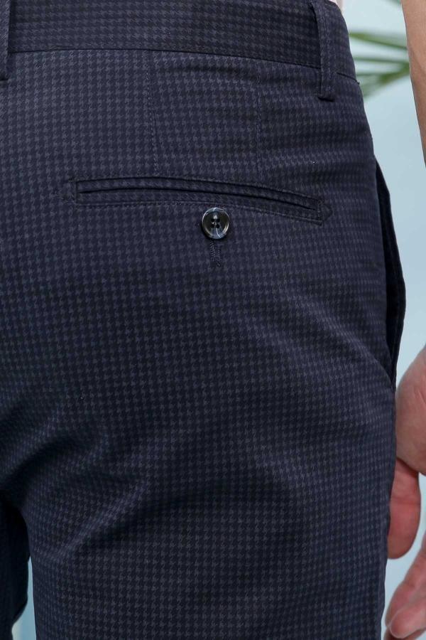 Navy cross-pocket pocket detail with button and textured fabric pattern