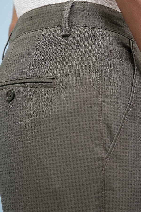 Olive green pants close-up, buttoned fly and waistband with belt loop