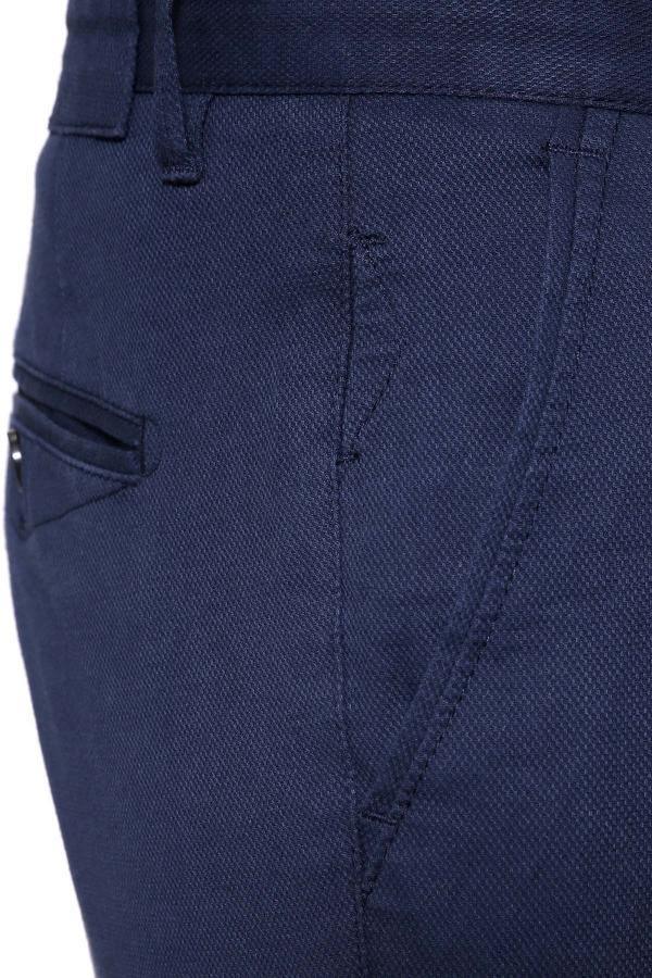 Navy pants pocket detail with stitched seams and button closure