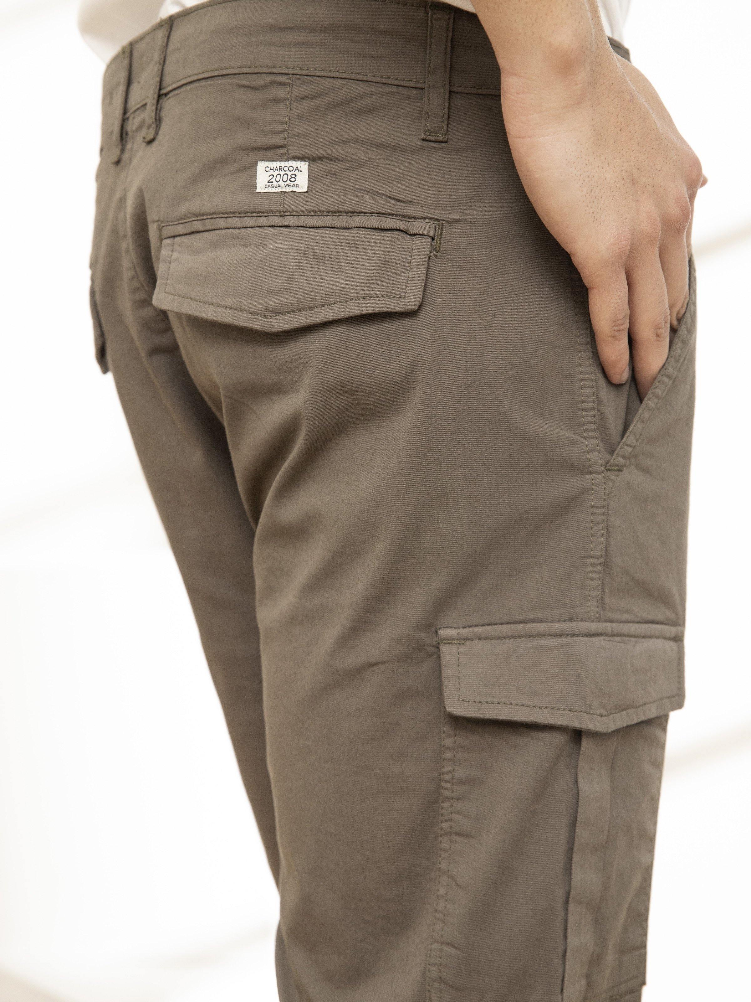 Olive cargo shorts side view with flap cargo pocket and waistband tab.