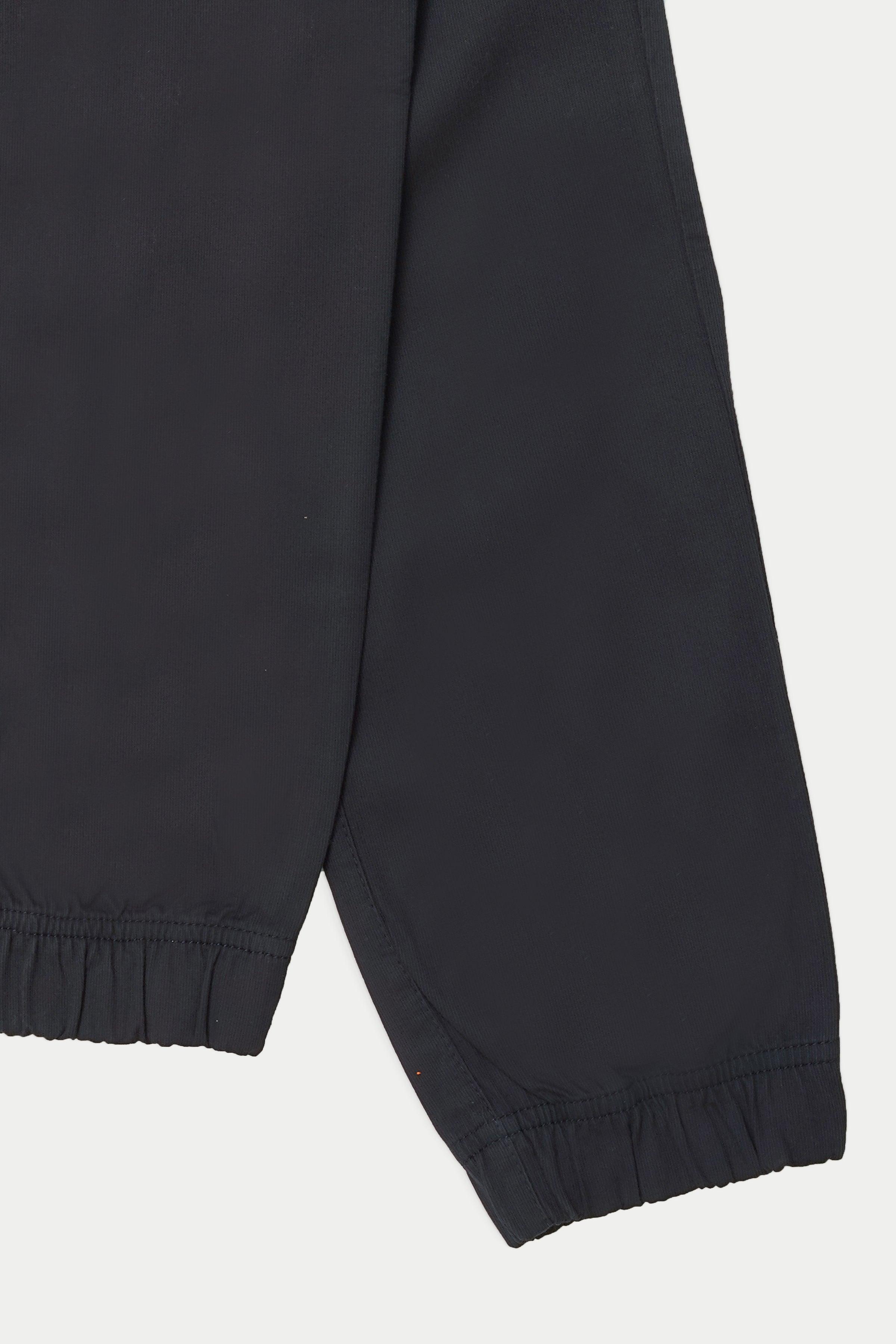 Navy cargo trousers with elastic cuffs at ankle, tapered leg