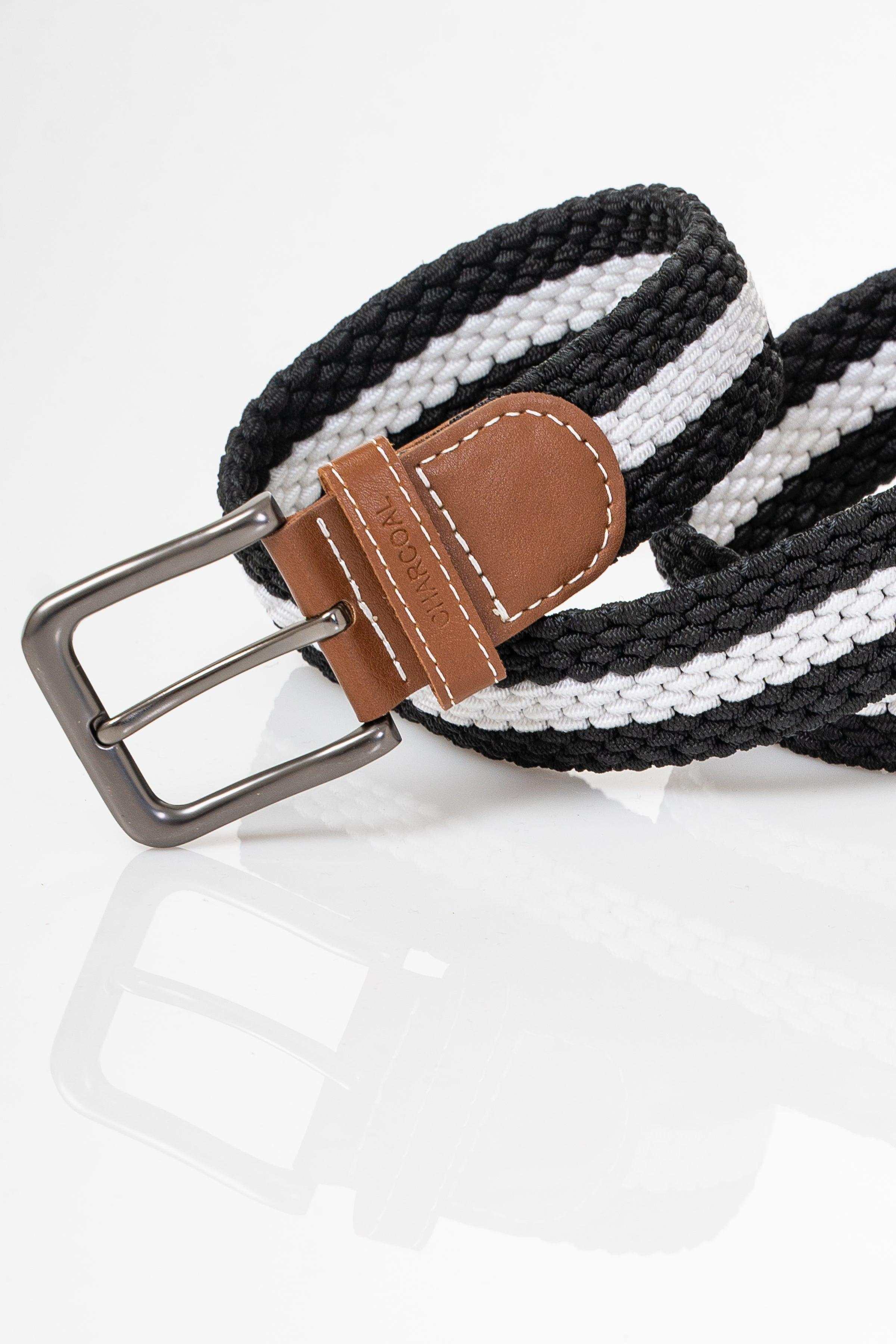 Braided belt detail: brown leather end tab with stitched edge and silver pin buckle