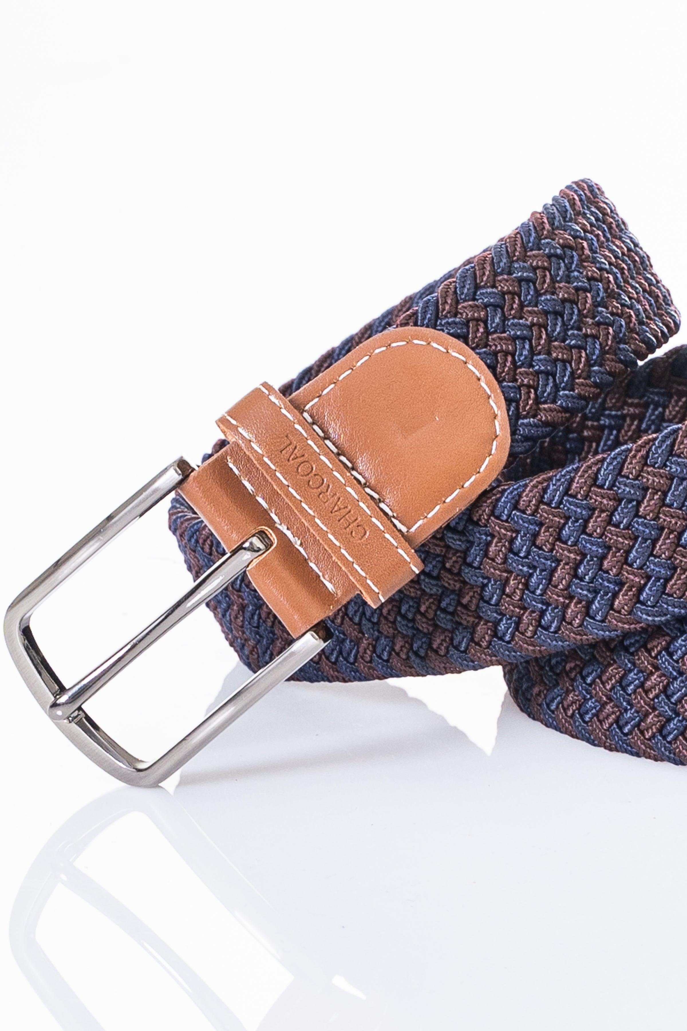 Casual belt close-up with woven navy-blue weave, tan leather patch, silver buckle