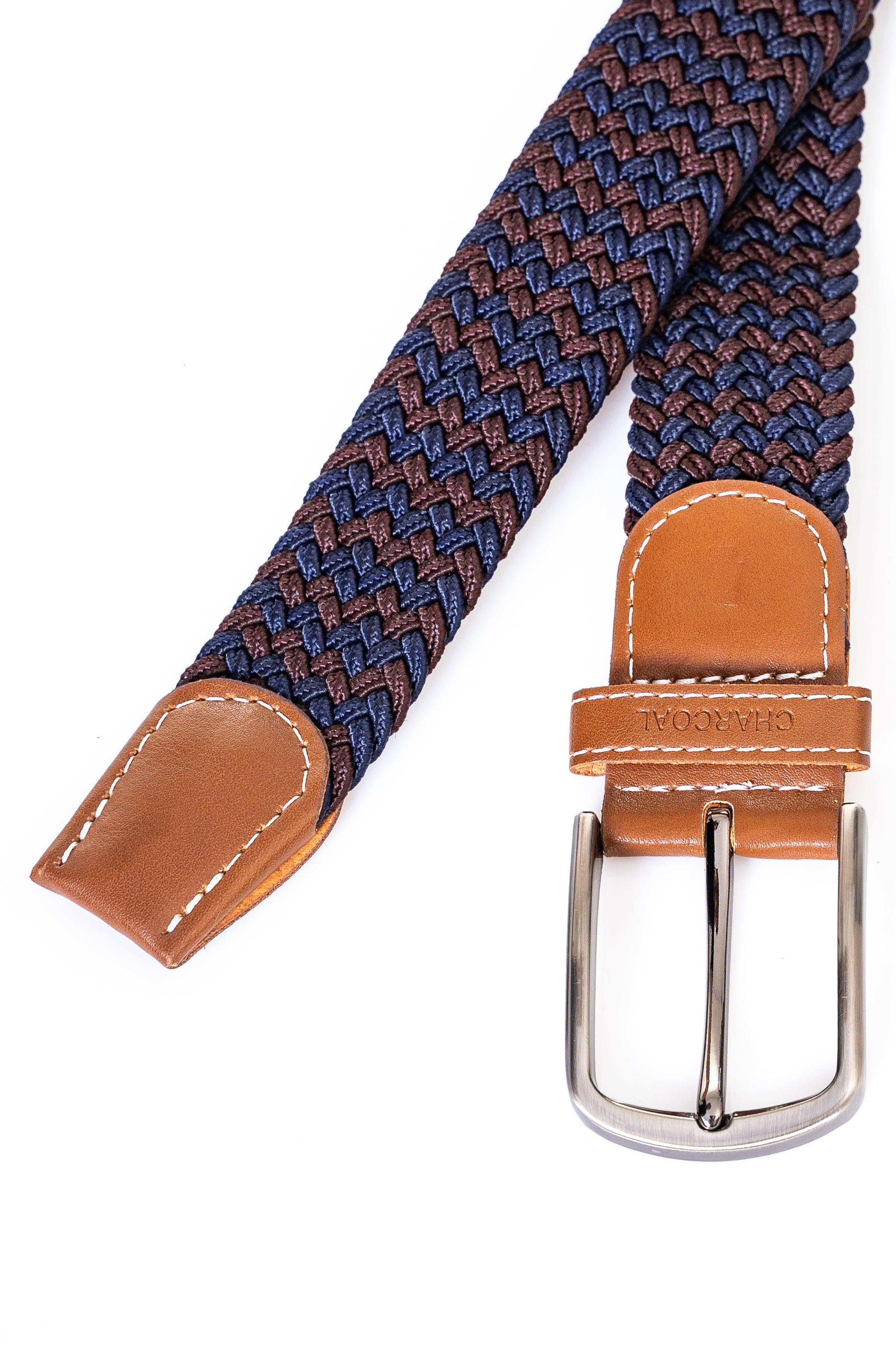 Woven belt strap detail with navy-blue pattern, tan leather tabs and silver buckle