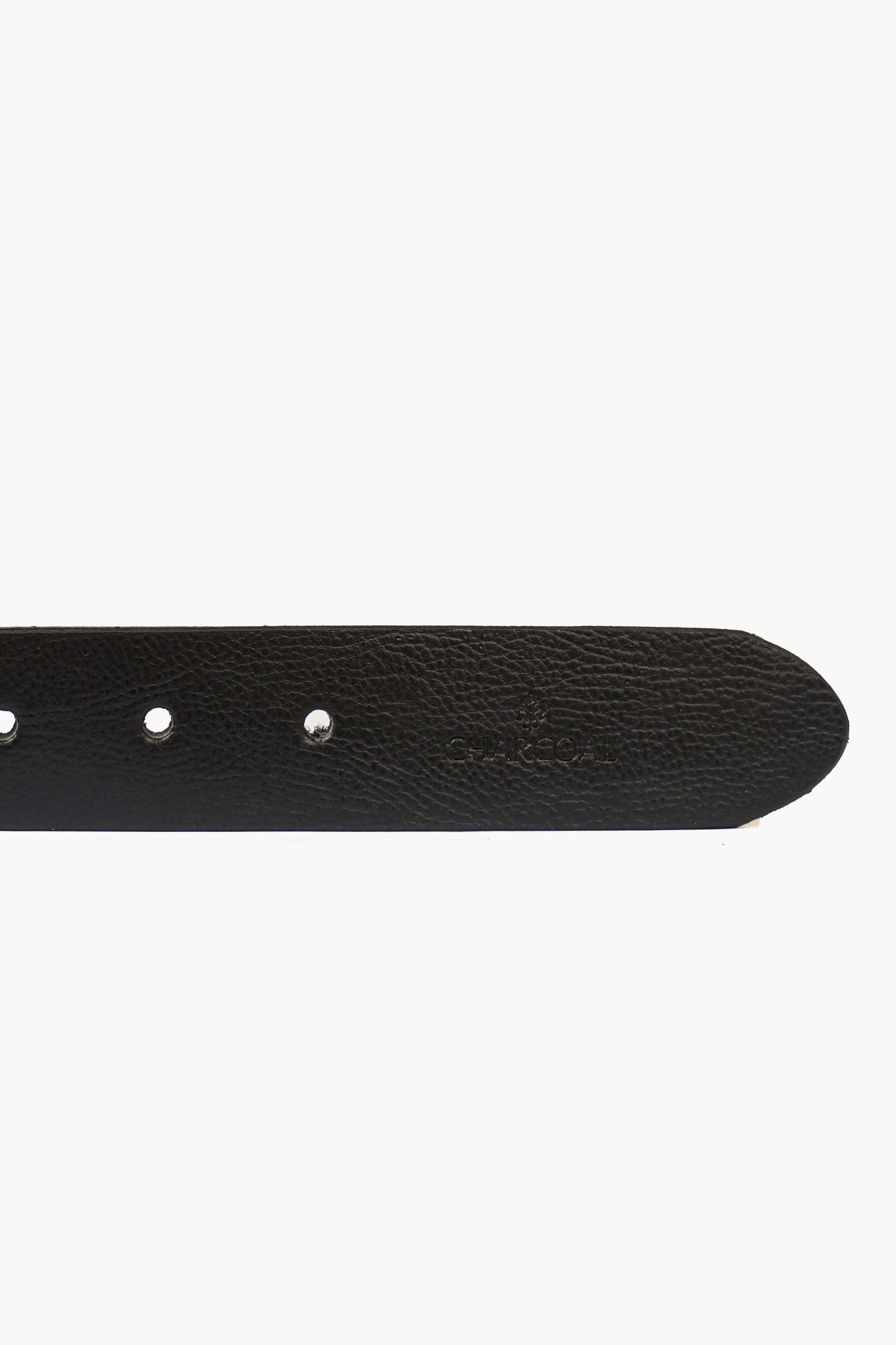 Dark leather belt end with three metal eyelets and visible grain texture