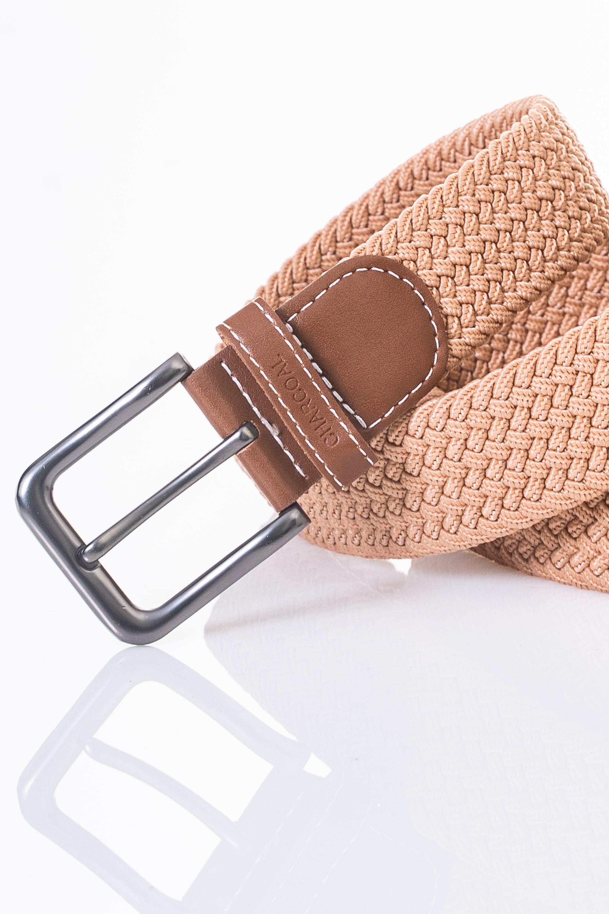 Casual belt close-up with tan weave, brown leather pad and silver prong buckle.
