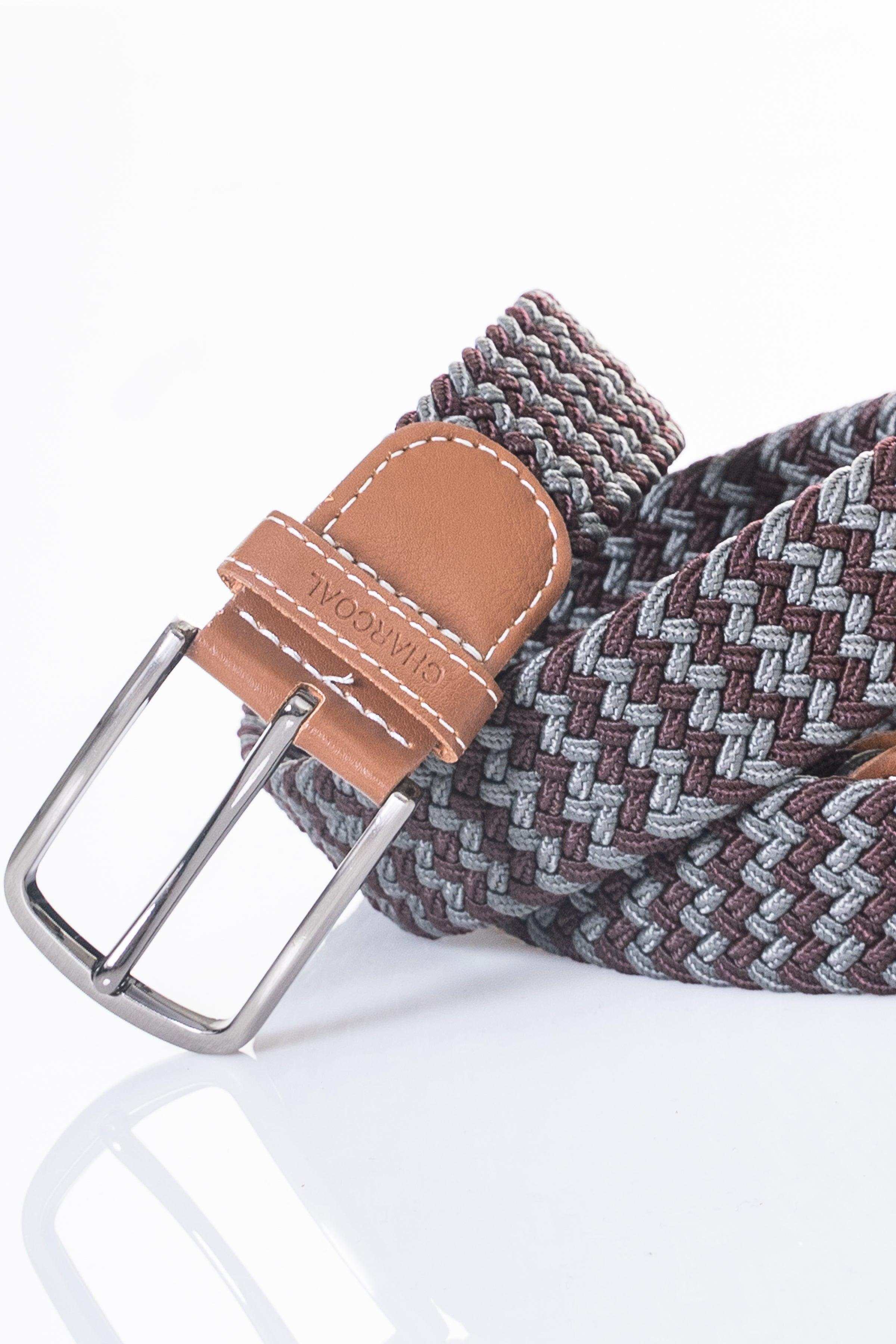 Braided belt detail with tan leather keeper and end panel, silver metal buckle