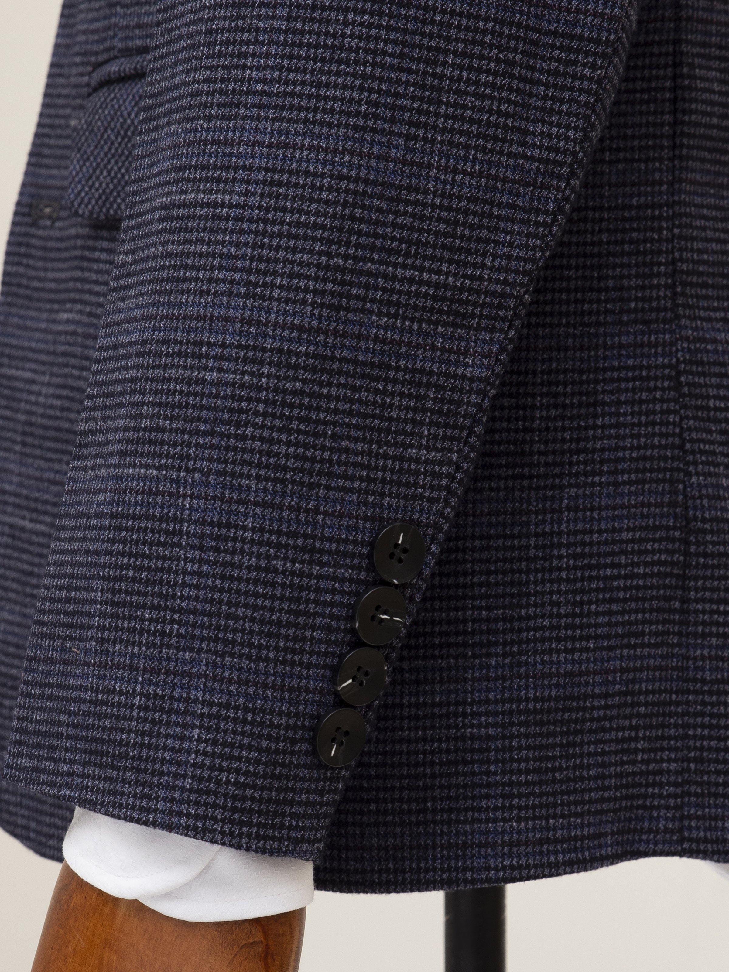 Navy coat sleeve with buttoned cuff and textured front panel