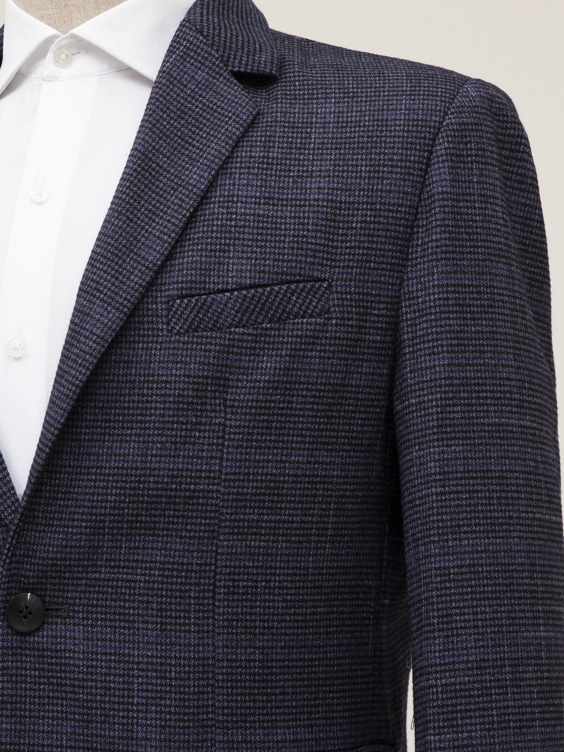 Navy textured coat lapel with chest welt pocket and button front