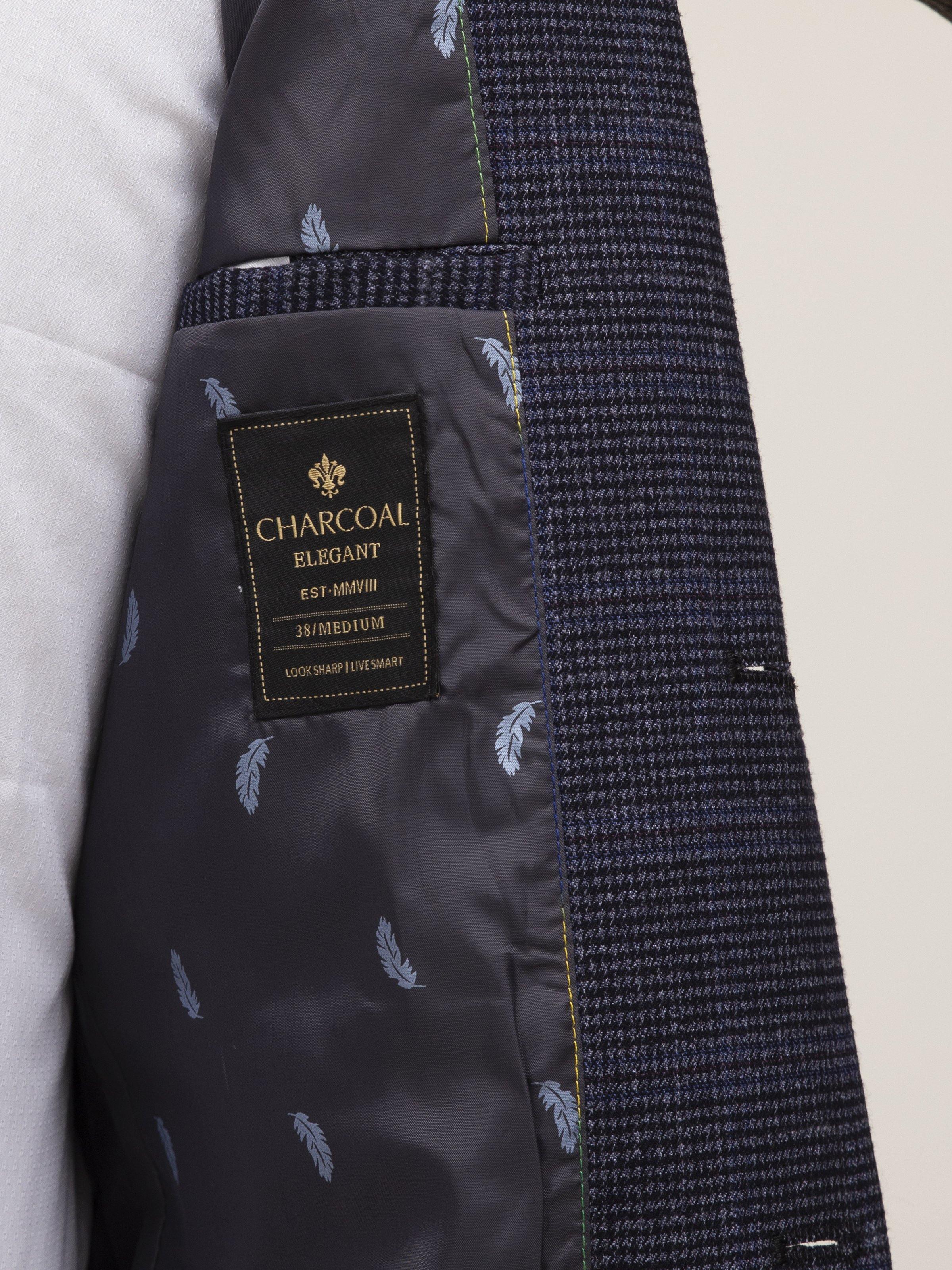Navy coat lining with CHARCOAL ELEGANCE tag and small leaf print