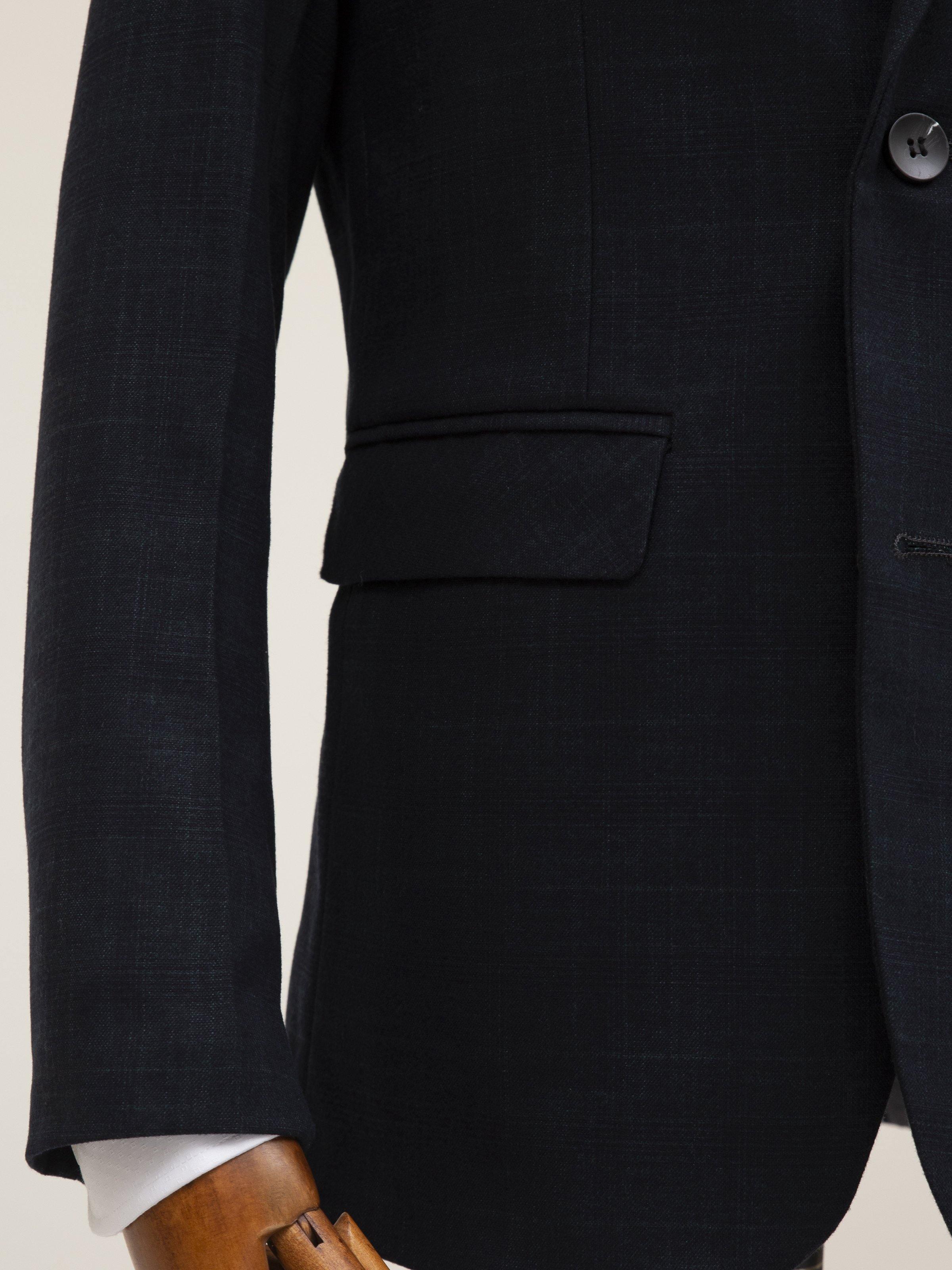 Dark coat with flap chest pocket and front welt pocket