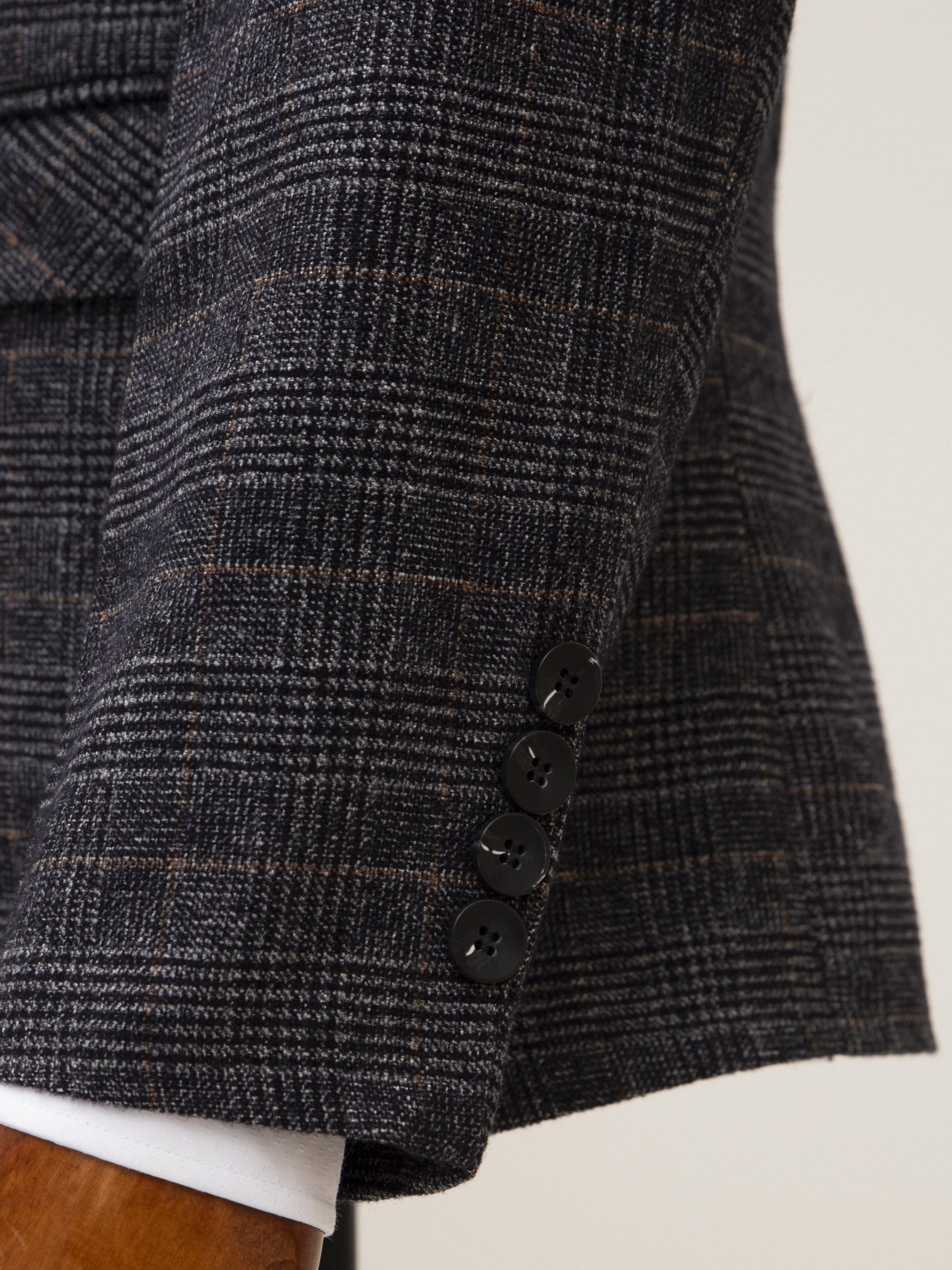 Grey plaid coat hem with two-button front and cuffed white lining
