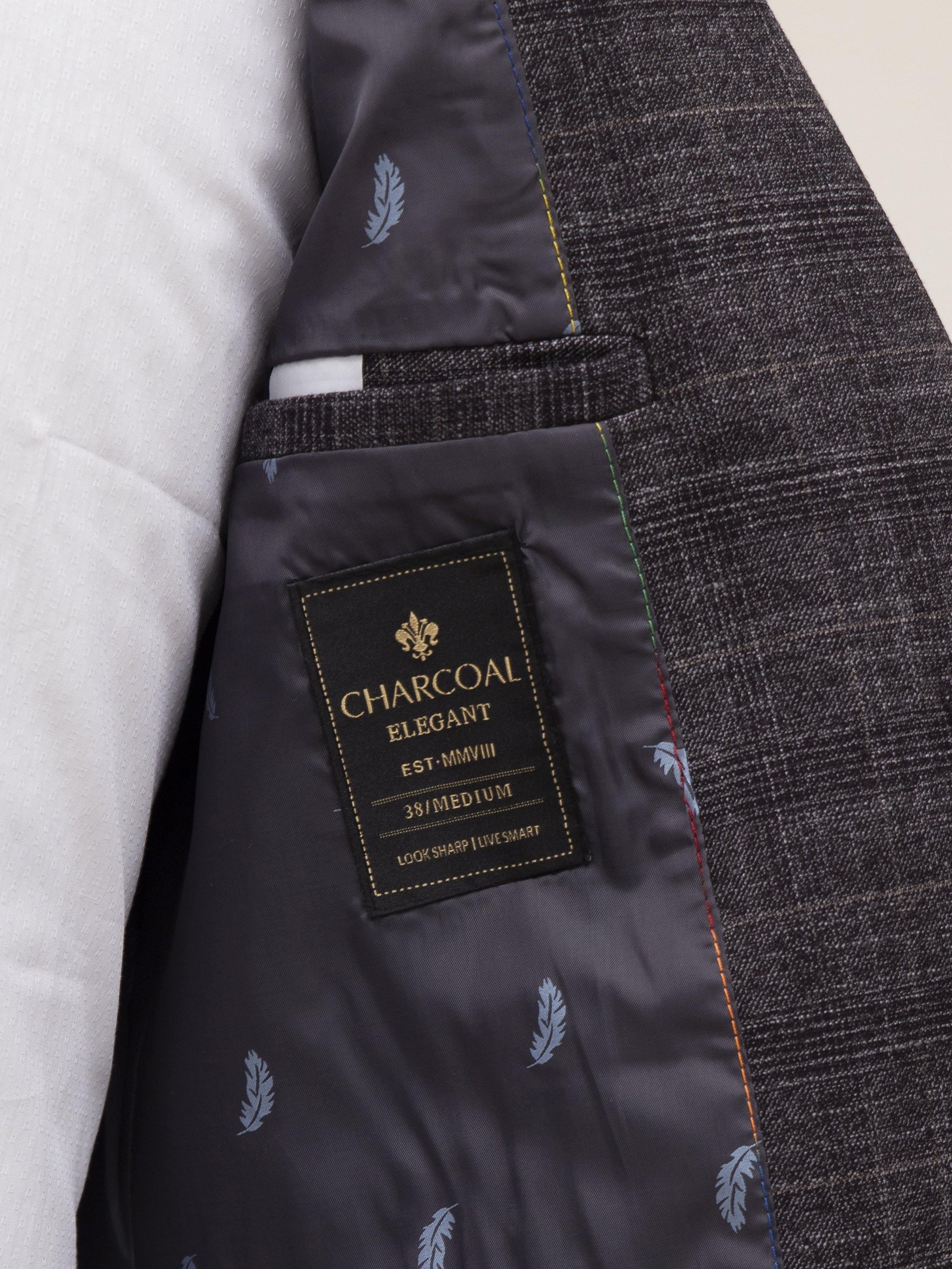 Inner lining of dark grey coat with pocket label and leaf-pattern lining