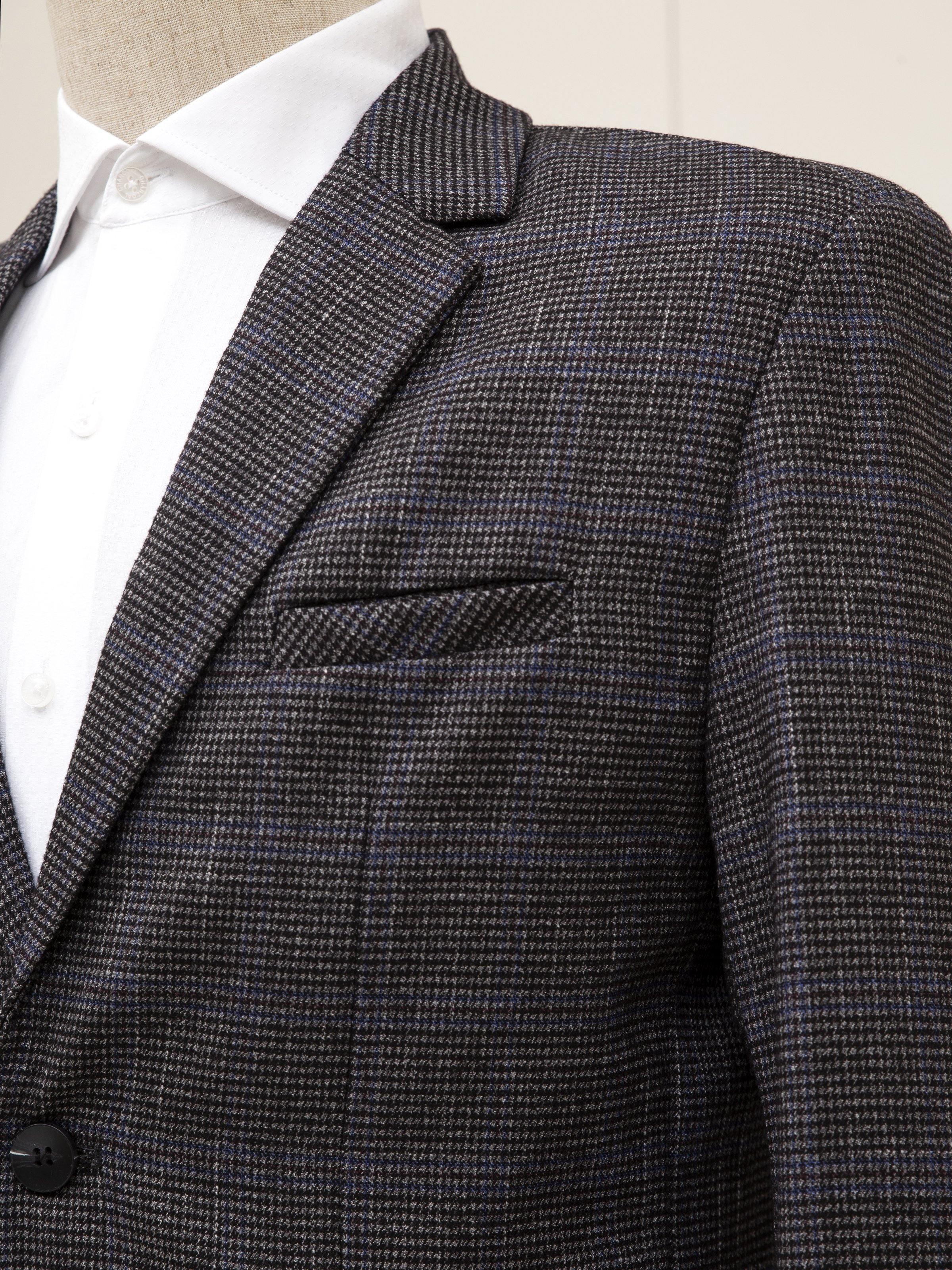 Grey coat lapel and chest pocket with two-button front detail