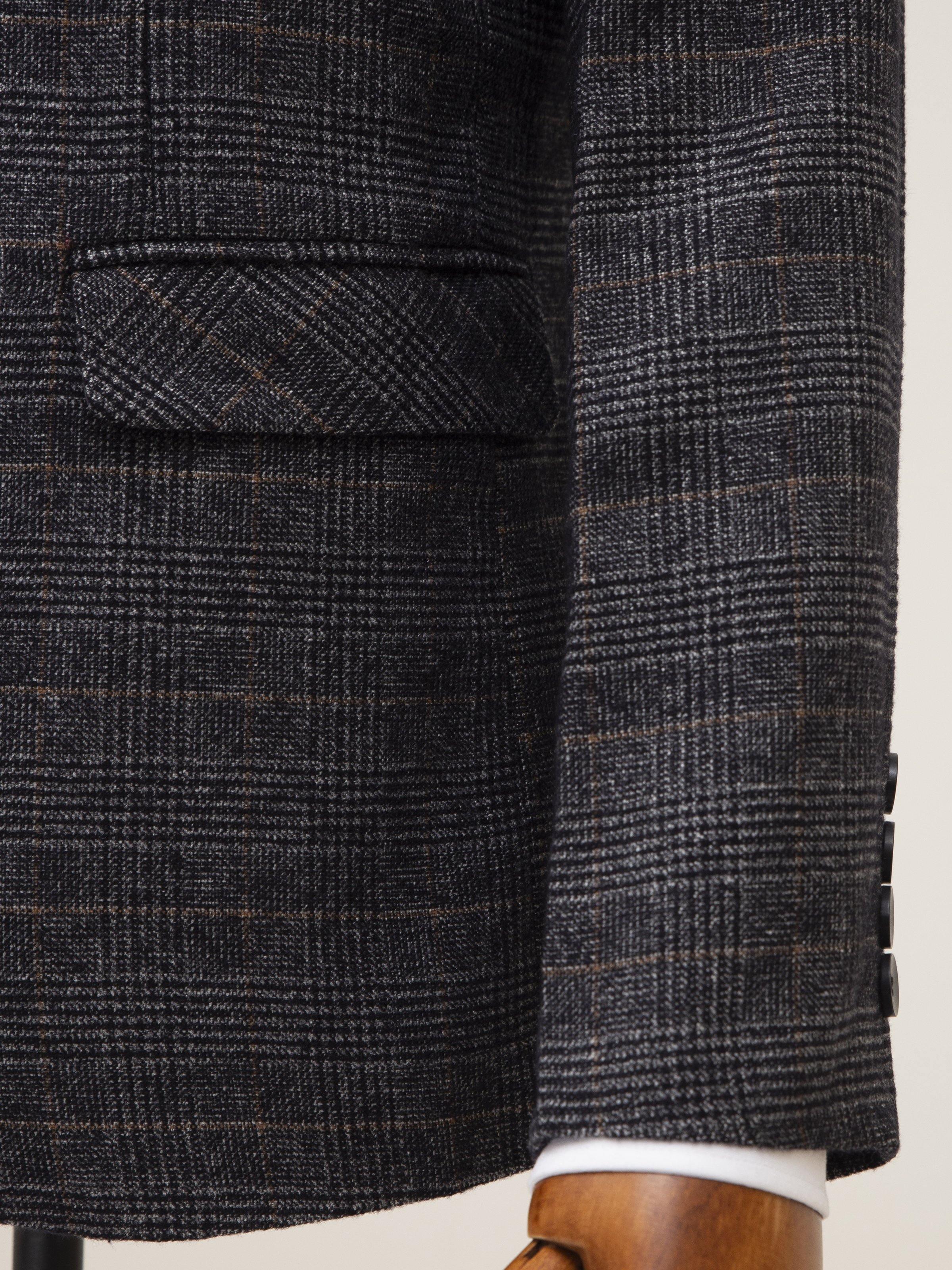 Grey plaid coat fabric close-up with textured check pattern