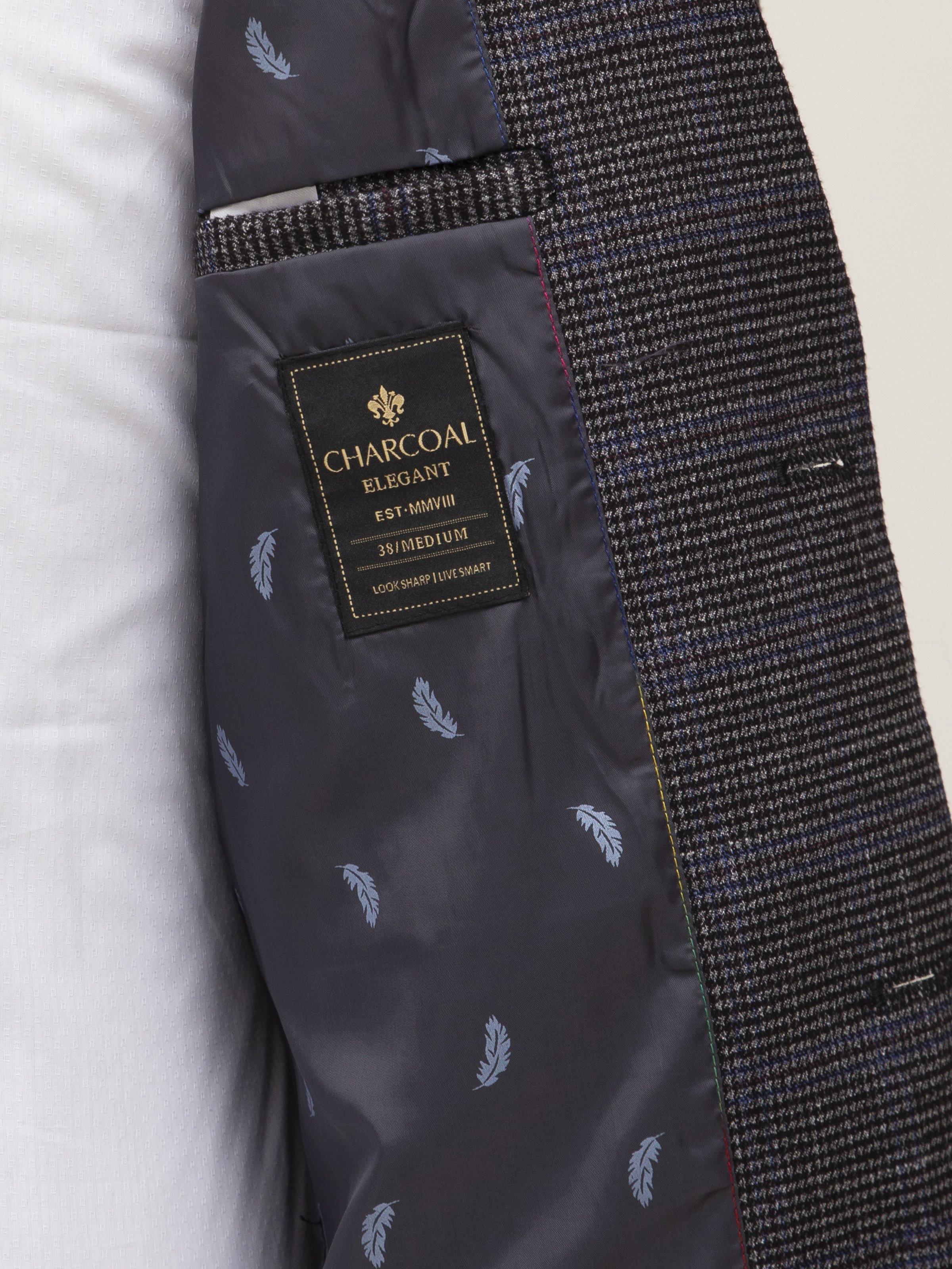 Grey coat lining with Charcoal Elegance label and subtle leaf pattern