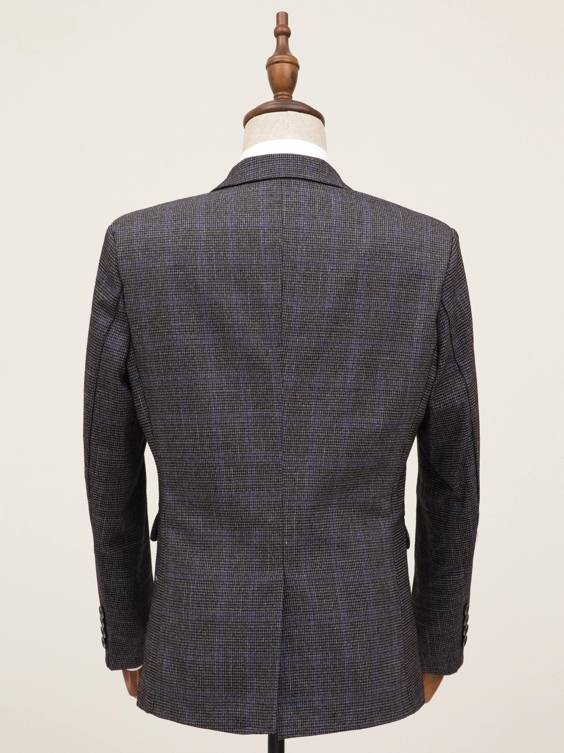 Grey coat back view with center seam and tailored shoulders on mannequin