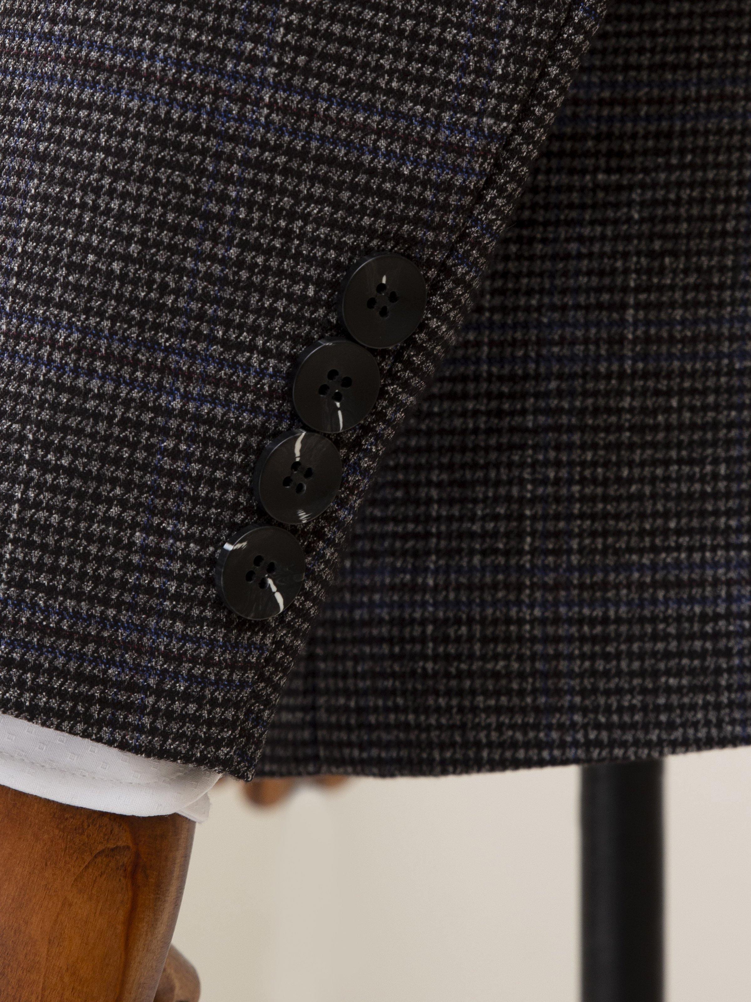 Grey coat sleeve cuff and front hem with dark button closures detail