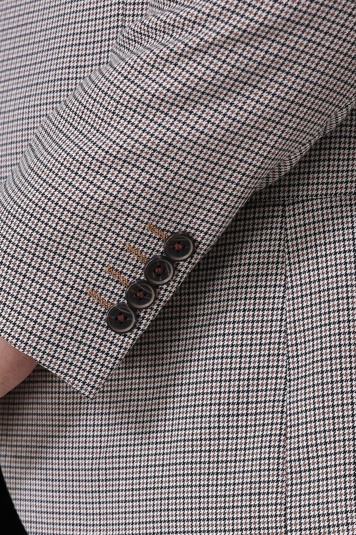 Houndstooth sleeve cuff with three dark buttons, beige and black check