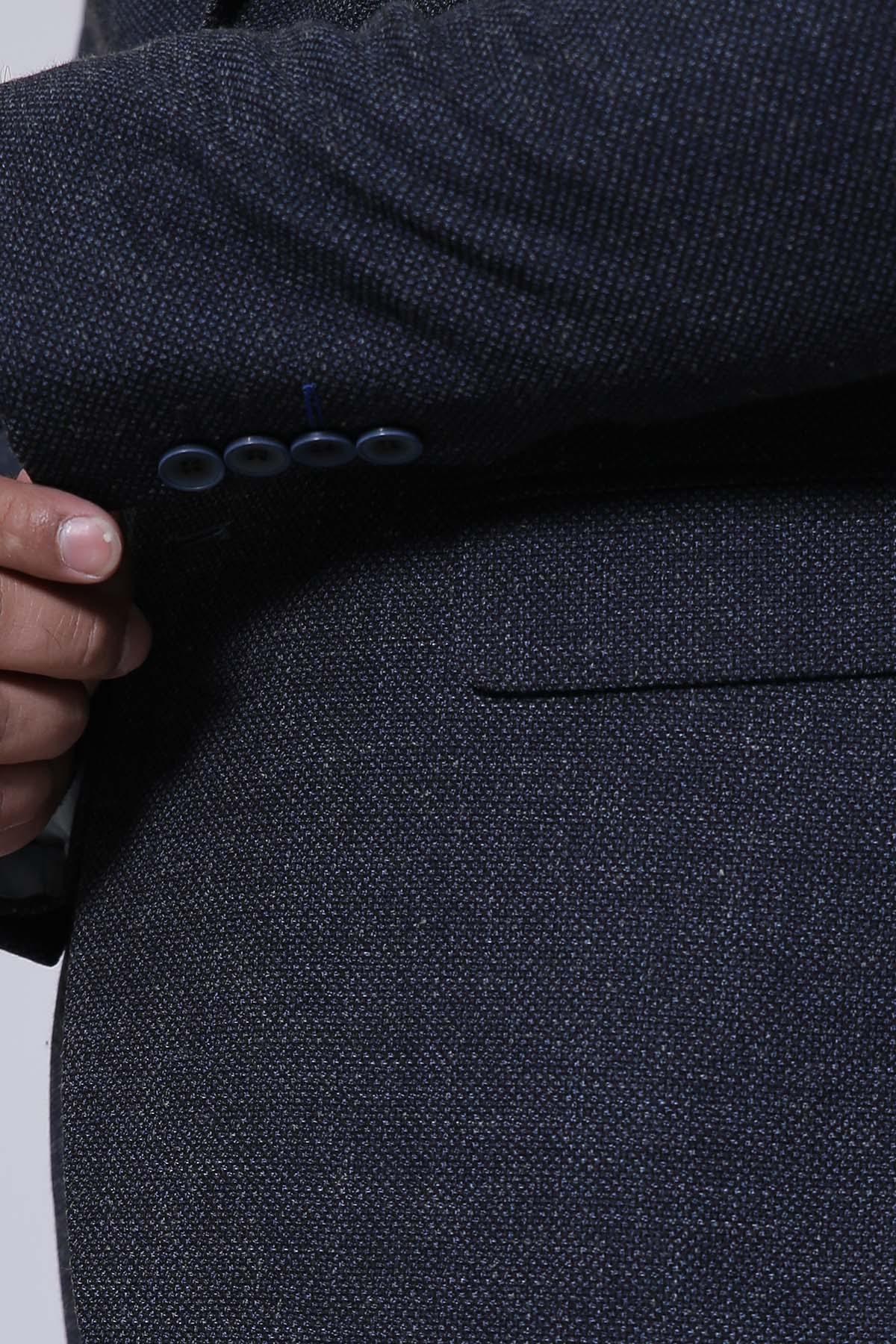 Navy coat button placket and lapel detail with two dark buttons