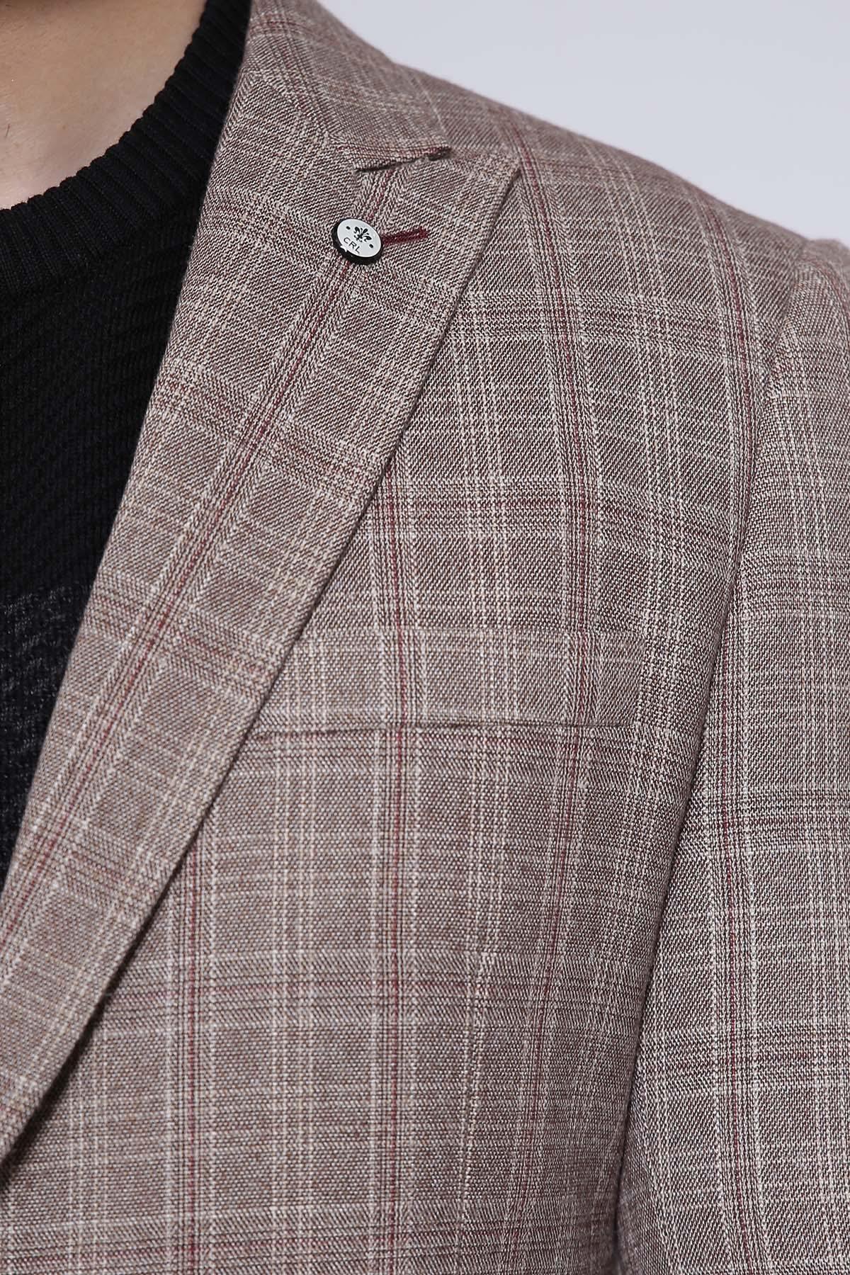 Light brown check coat shoulder with decorative button and structured seam